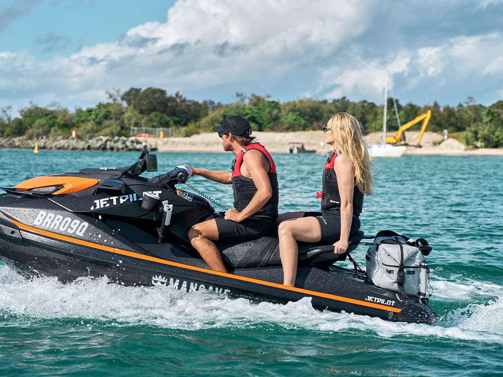 Couple wearing foam Jetpilot life vests on a Sea-Doo, comparing PFD options for first-time Aussie boaters