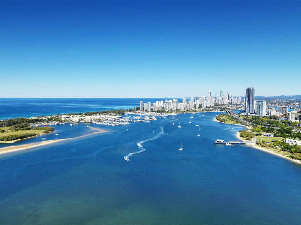 Aerial view of the Gold Coast Broadwater with jet skis, sandbars and the Surfers Paradise skyline beyond