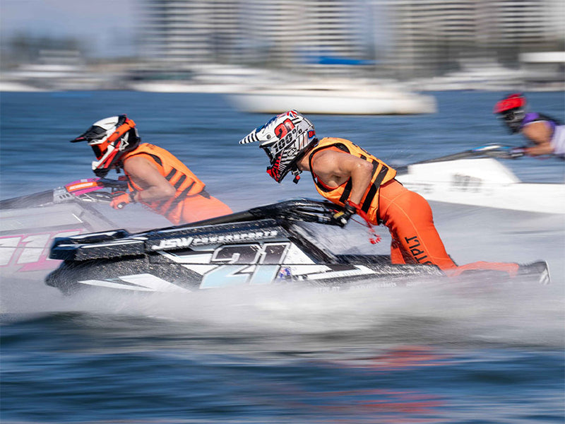 Two pro jet ski racers in orange Jetpilot race vests battling at speed during a Gold Coast Watercross event