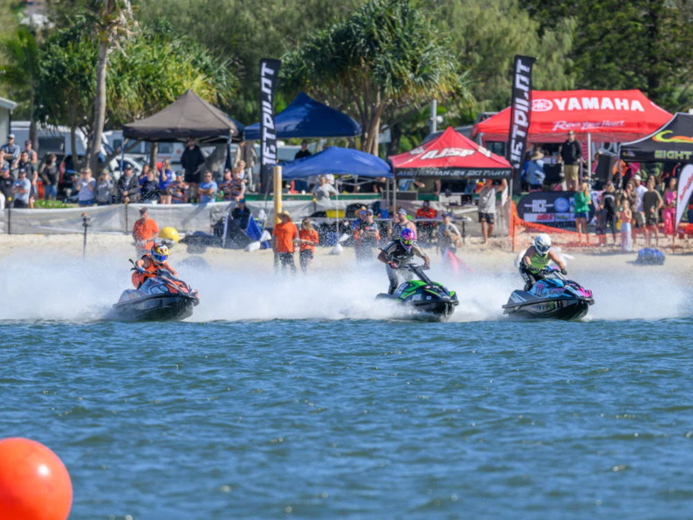Jet ski racers launching off the start line past Jetpilot and Yamaha tents at the Gold Coast Watercross Nationals
