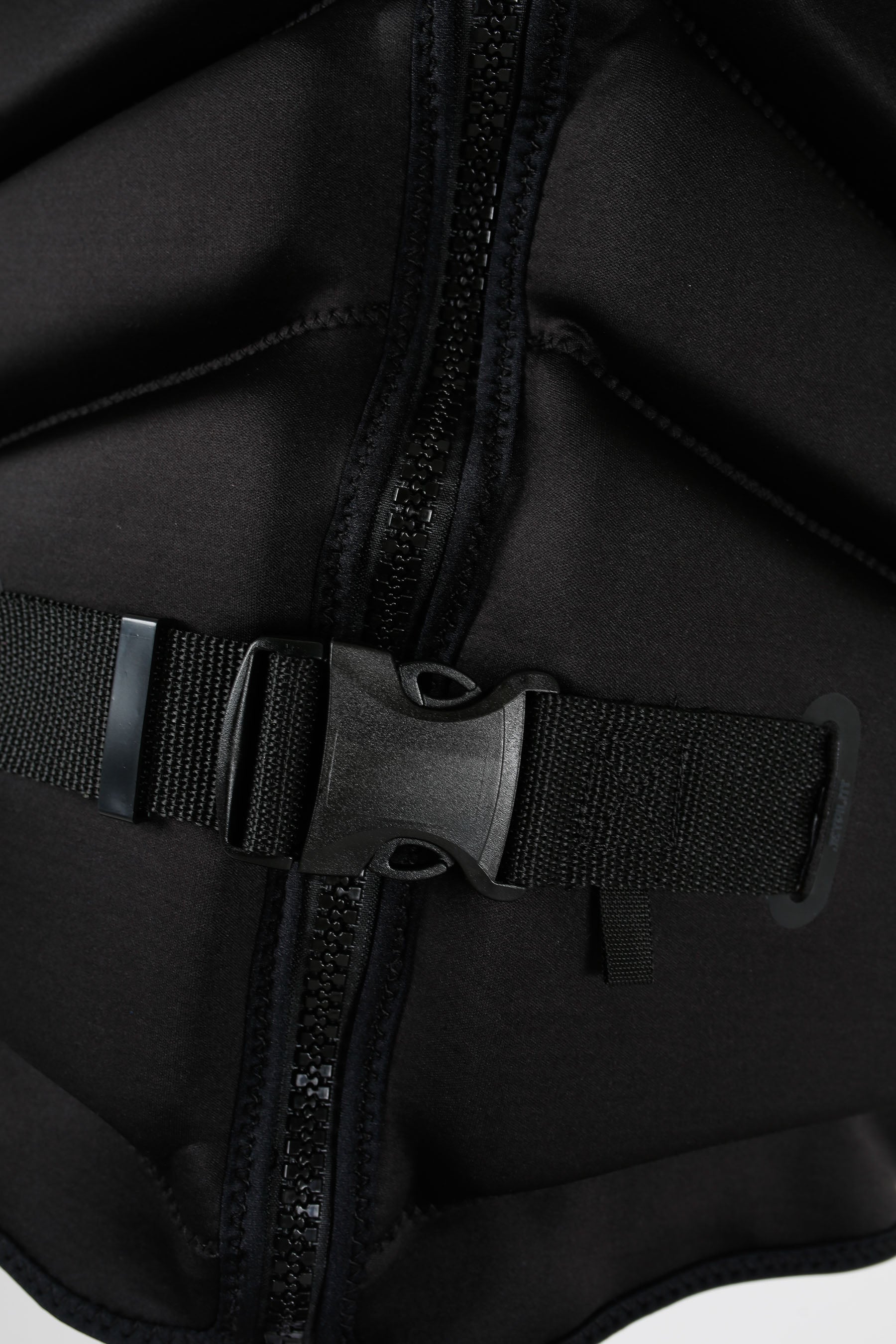 Close-up of a black life jacket with a buckle on a white background
