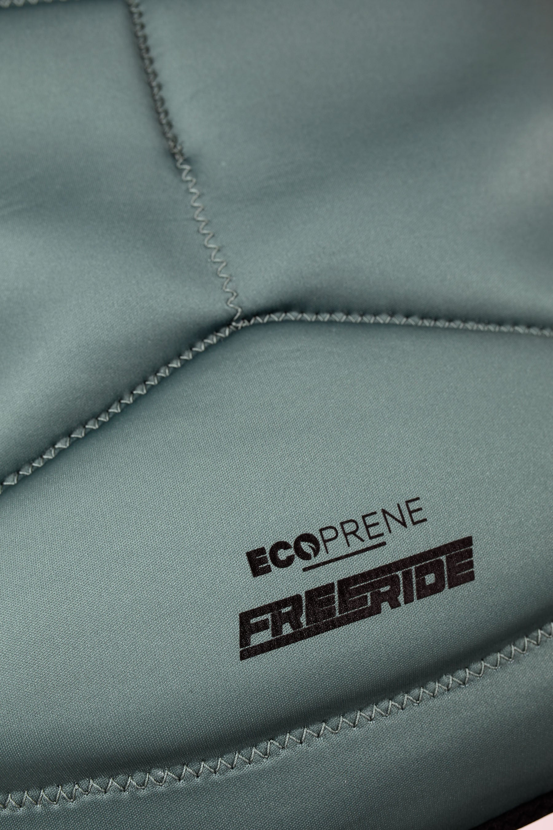 Close-up of a sage green eco friendly neoprene with 'Ecoprene Freeride' branding.