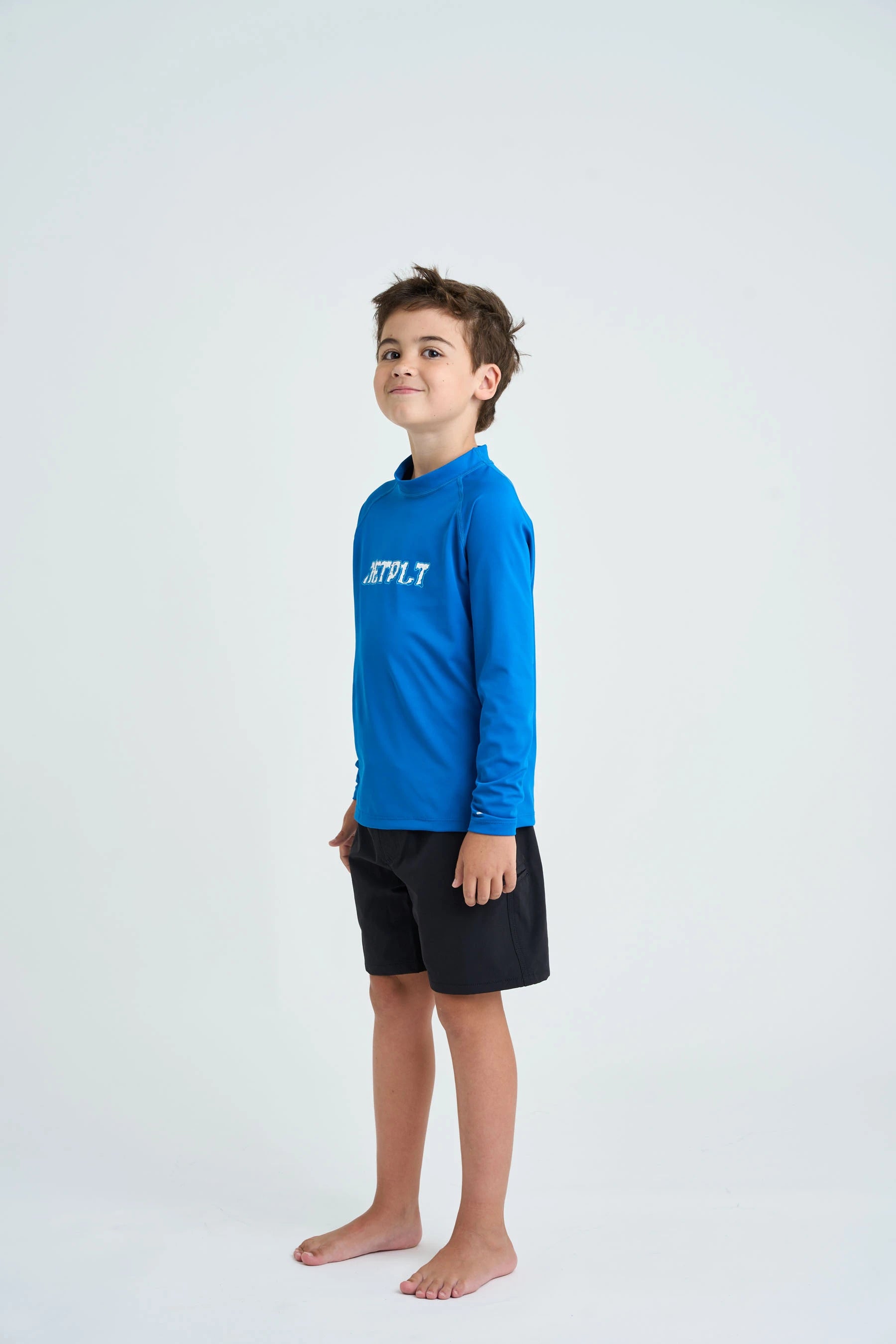 Child wearing a blue long-sleeve shirt with a logo on a white background
