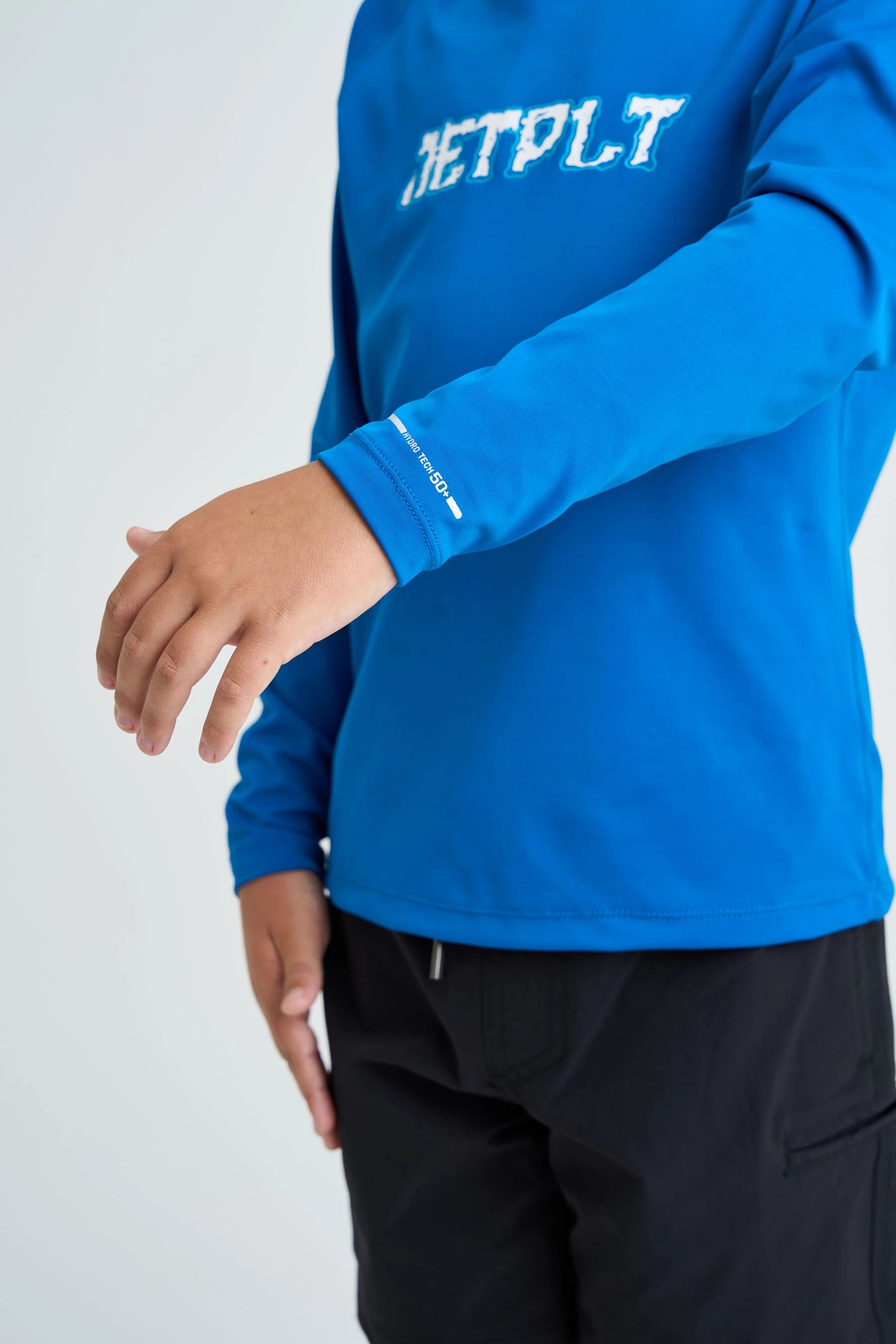 Blue long-sleeve rash shirt with 'JETPLT' text on a white background
