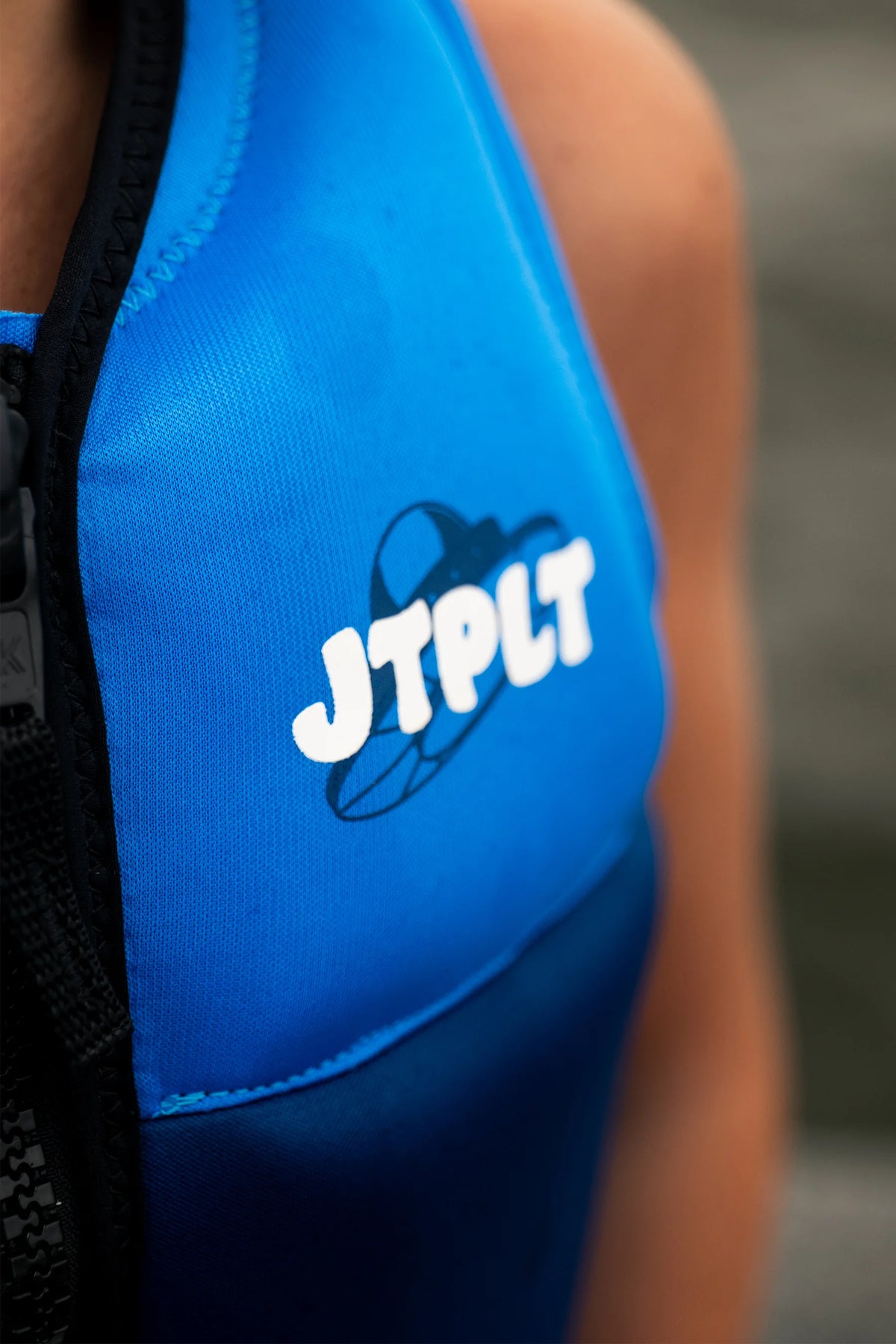Side-on close-up of the bubble JTPLT chest logo on the Blue Freeride Boys, worn by a young rider