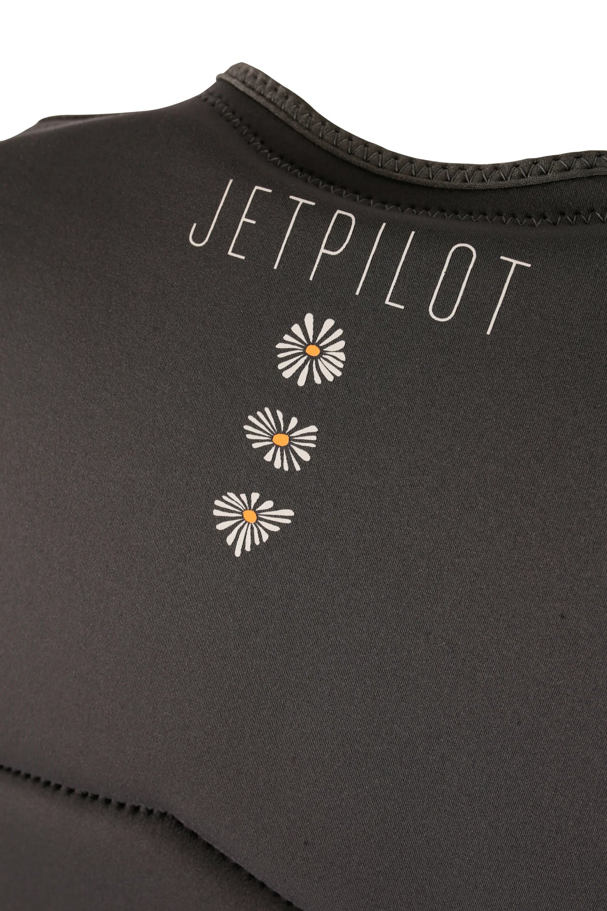 Close-up of the Jetpilot name and three orange-centred daisies on the back of the Charcoal Isla