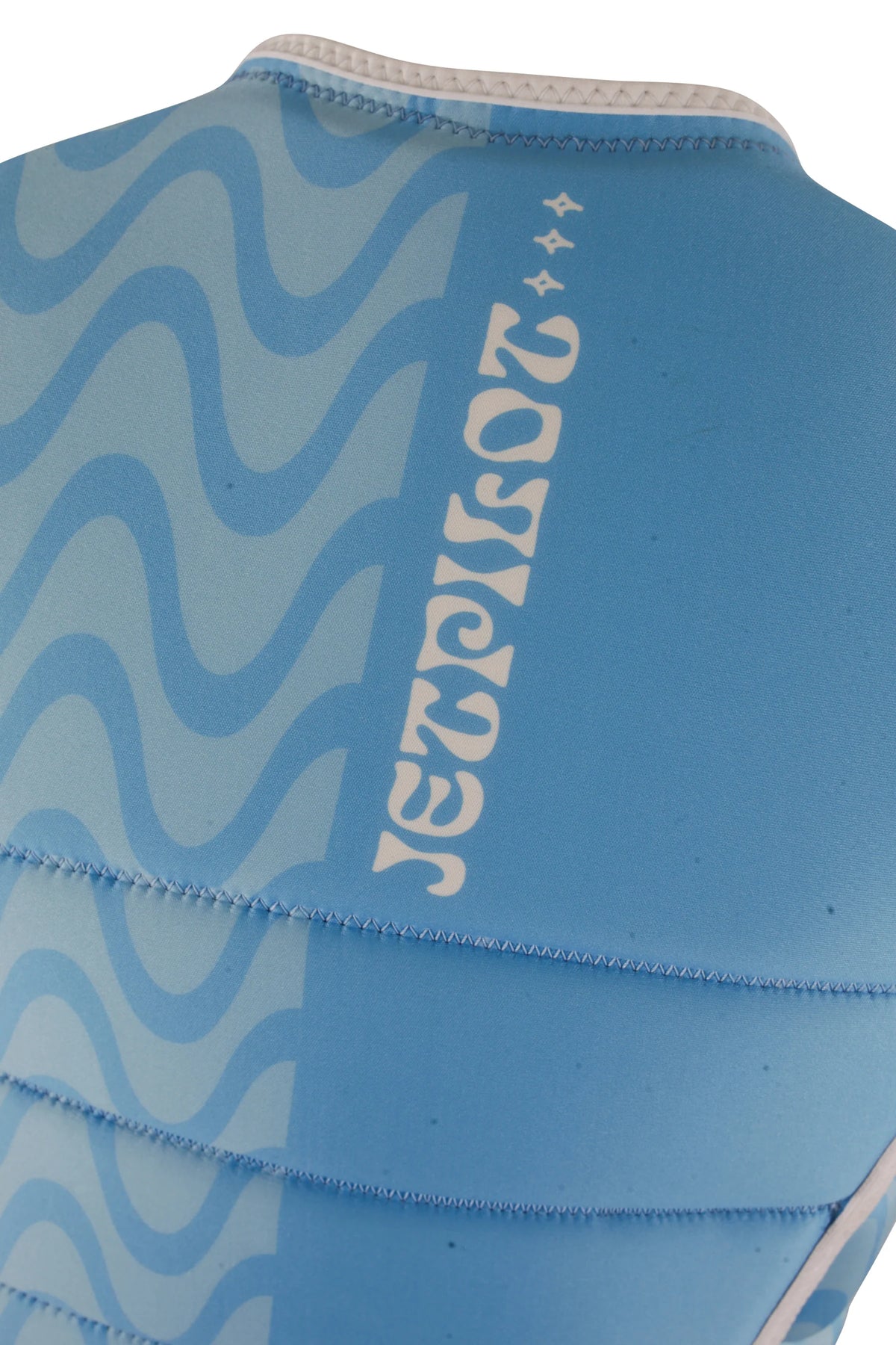 Close-up of the vertical Jetpilot logo and sparkles beside the waves on the back of the Blue Luna