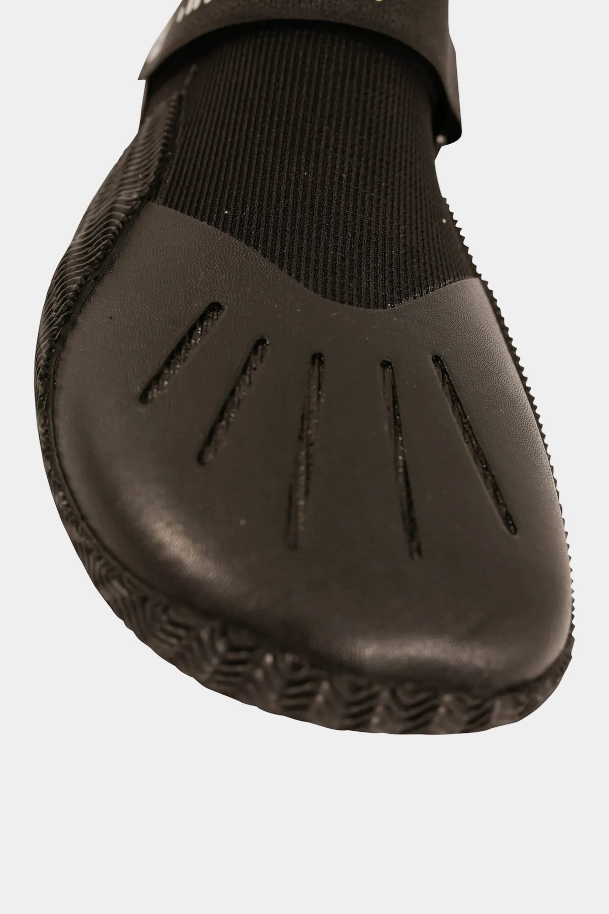 Close-up of the grooved rubber toe cap and sole edge on the Black Technical Hi-Cut shoe