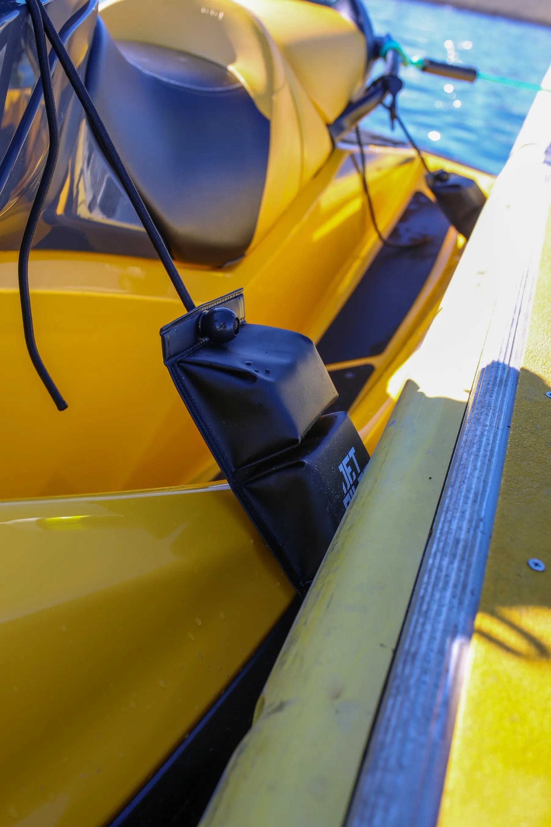 Close-up of a yellow jetski with a black tri-fender attached to the side. — view 2 (3)