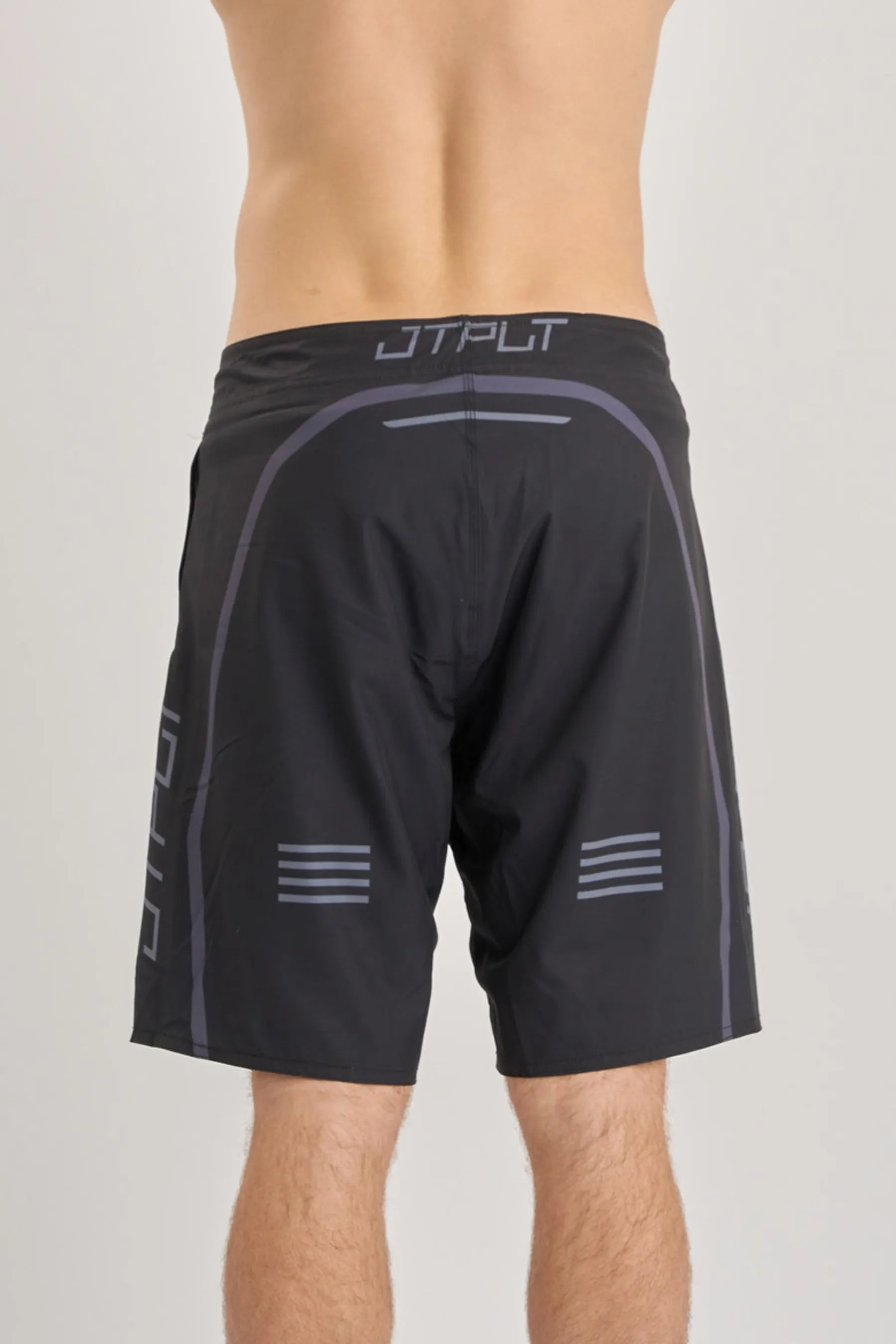 Black boardshorts with grey accents and branding on a plain background