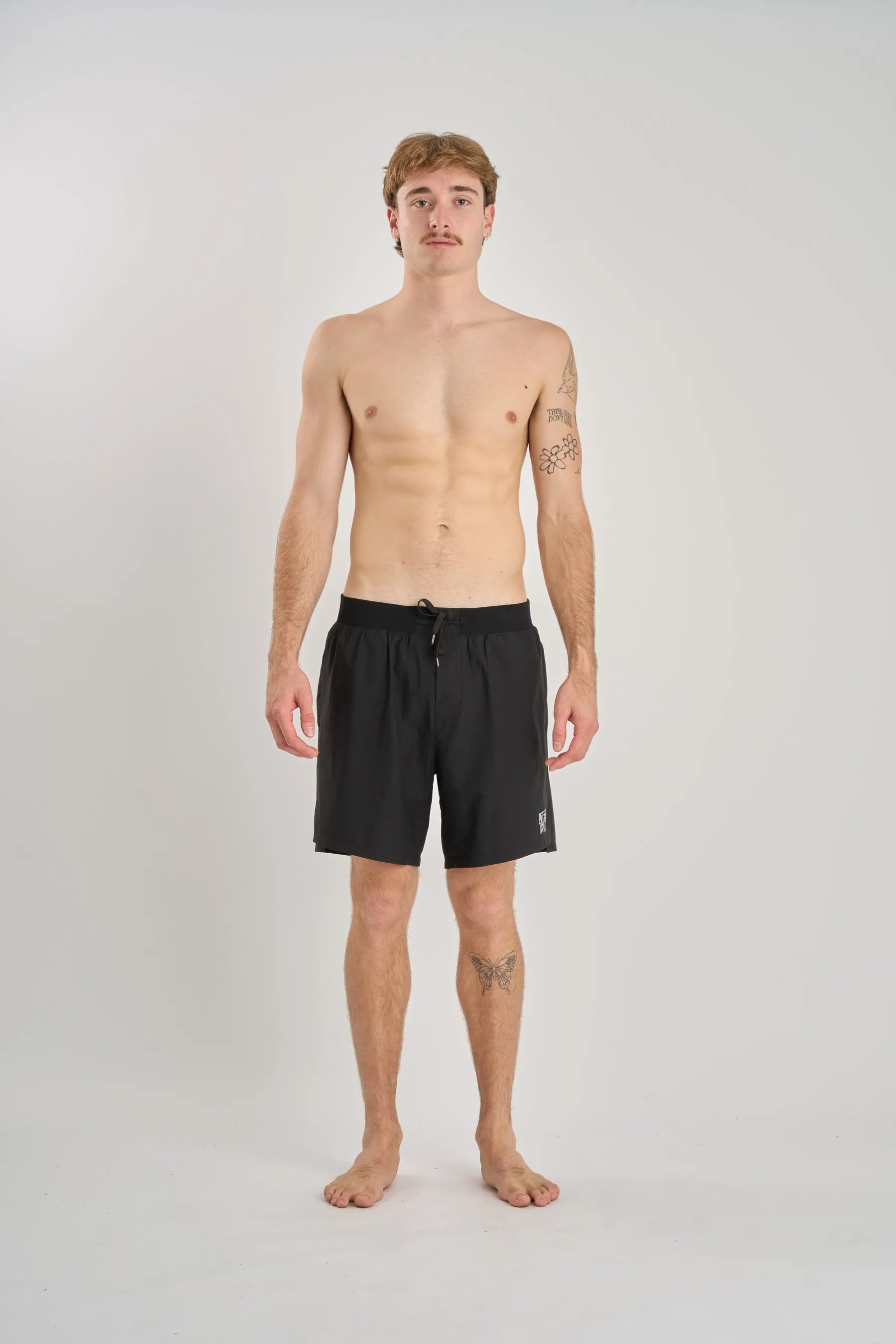 Man wearing black swim shorts on a white background — image 2