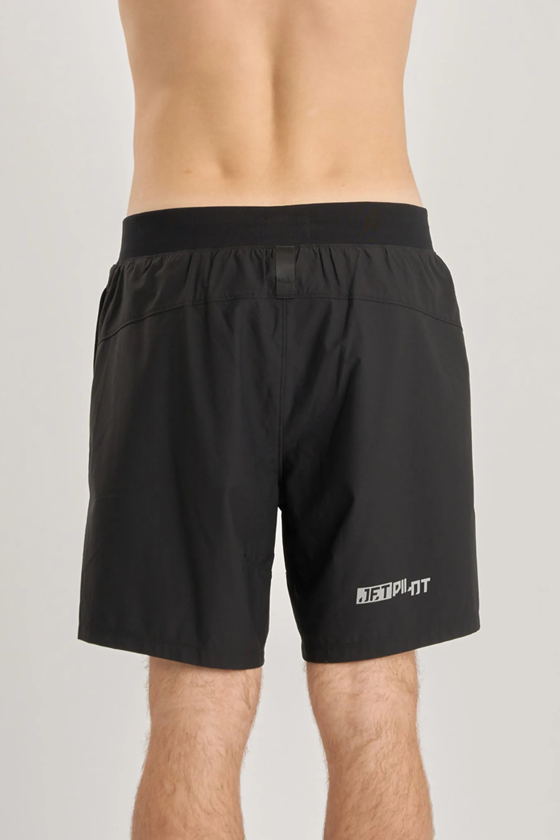 Black shorts with a brand logo on a gray background — image 2
