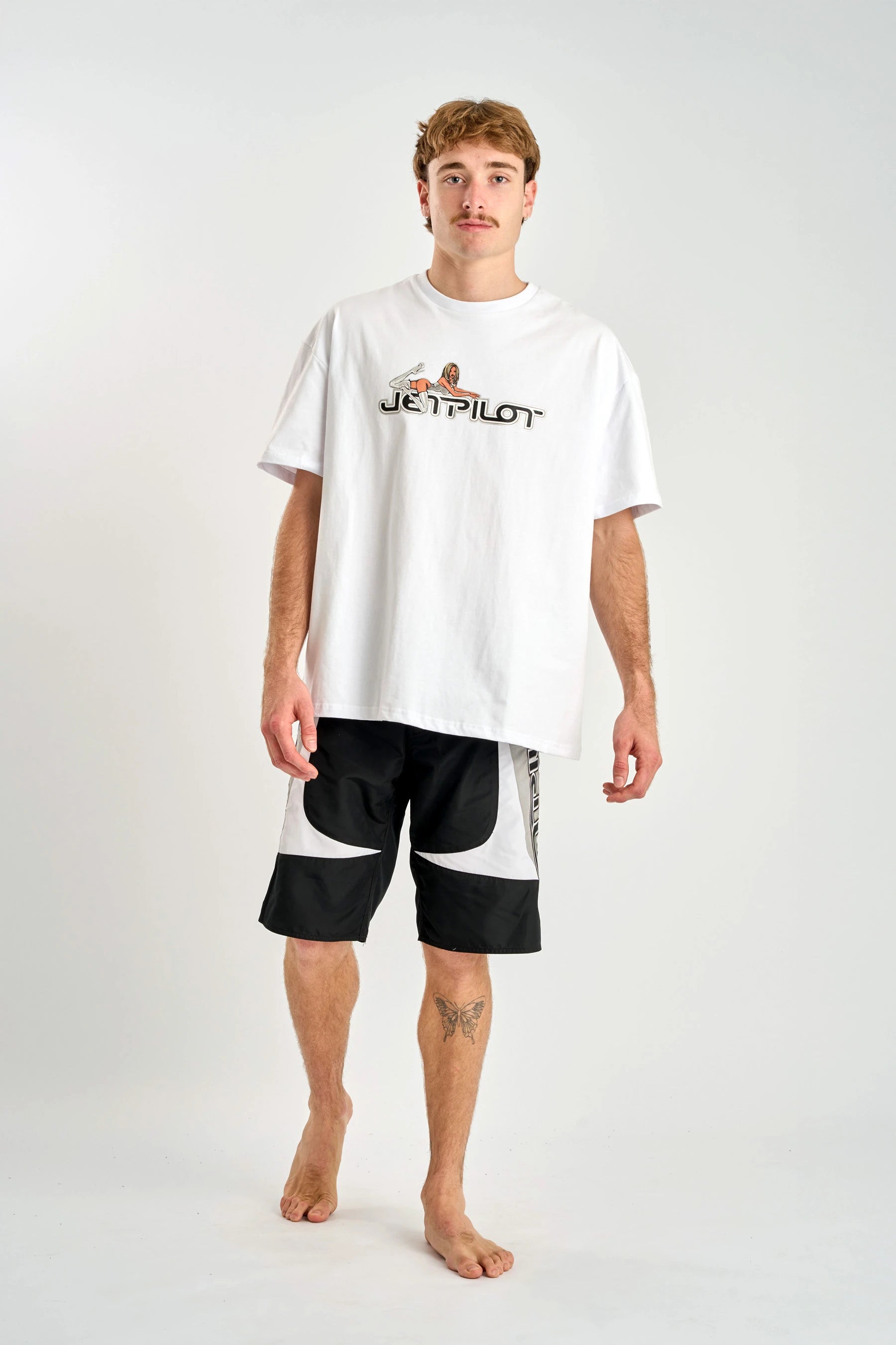 Person wearing a white t-shirt with 'Jetilot' logo and black shorts on a white background