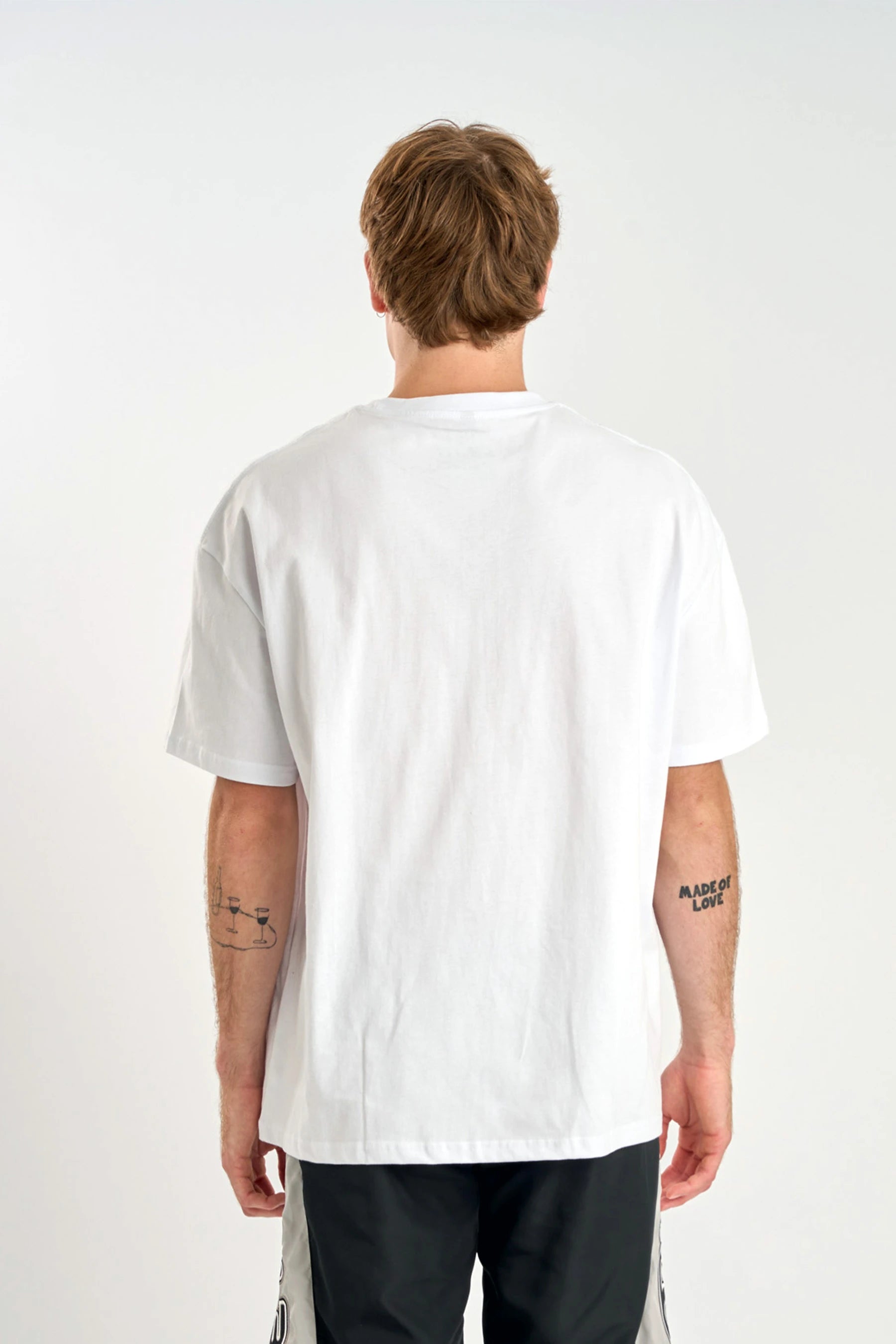 Person wearing a Jetpilot Moto Heavy Tee - White on a plain background