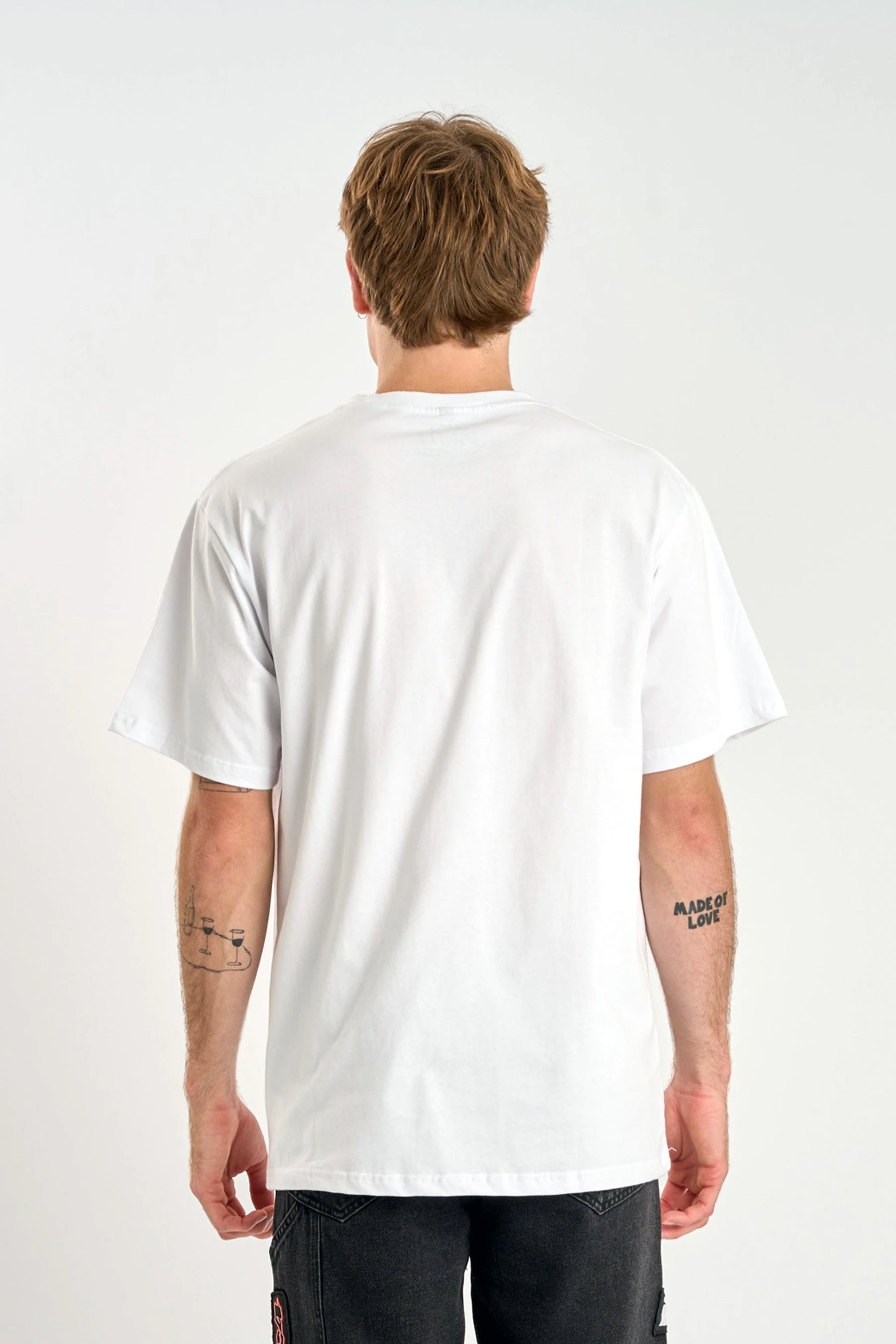 Person wearing a plain Jetpilot Pulse Streamliner Tee - White t-shirt on a light gray background — image 2