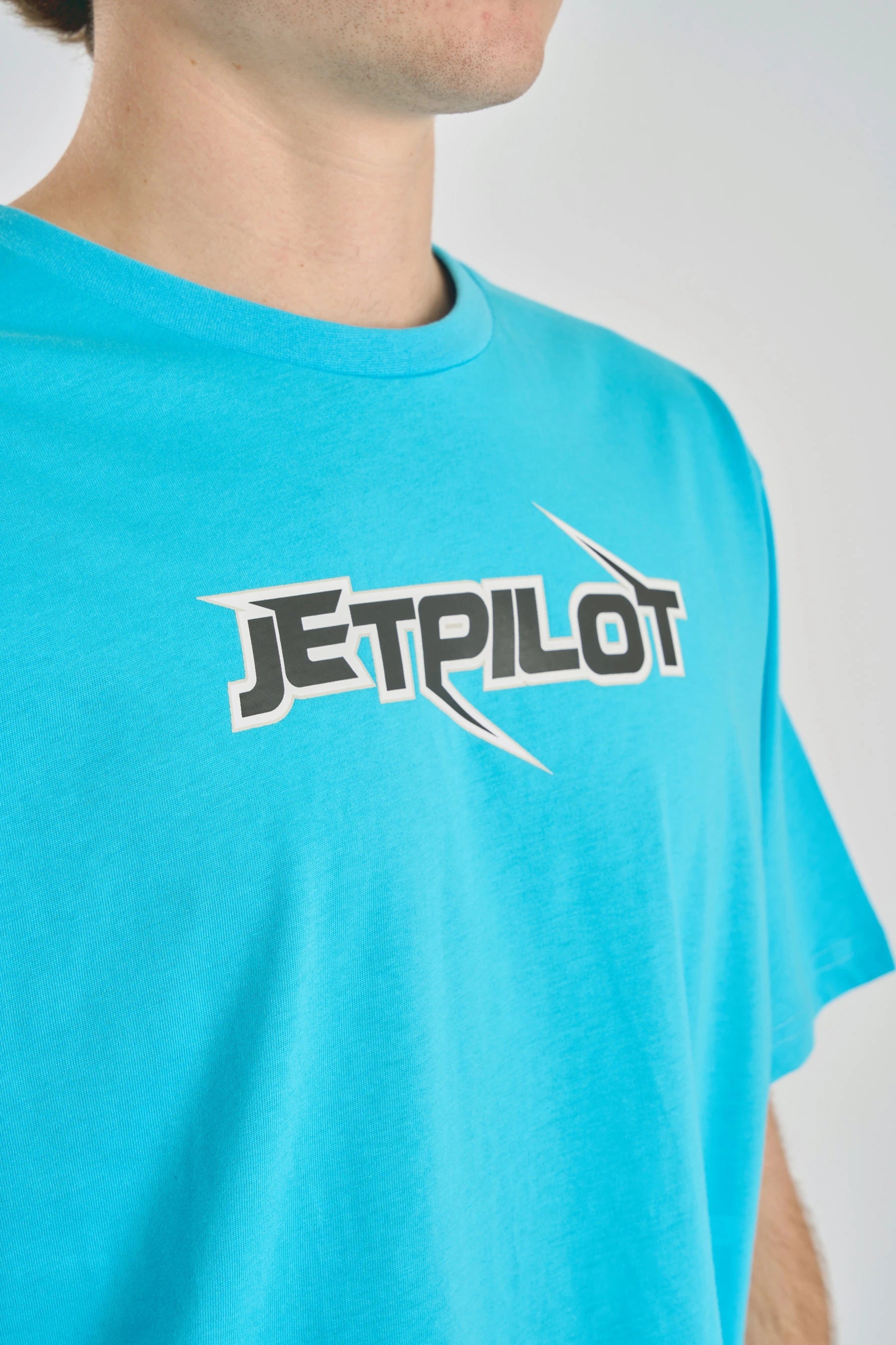 Person wearing a Jetpilot Raptor Tee - Blue t-shirt with 'JETPILOT' logo on a plain background — image 2