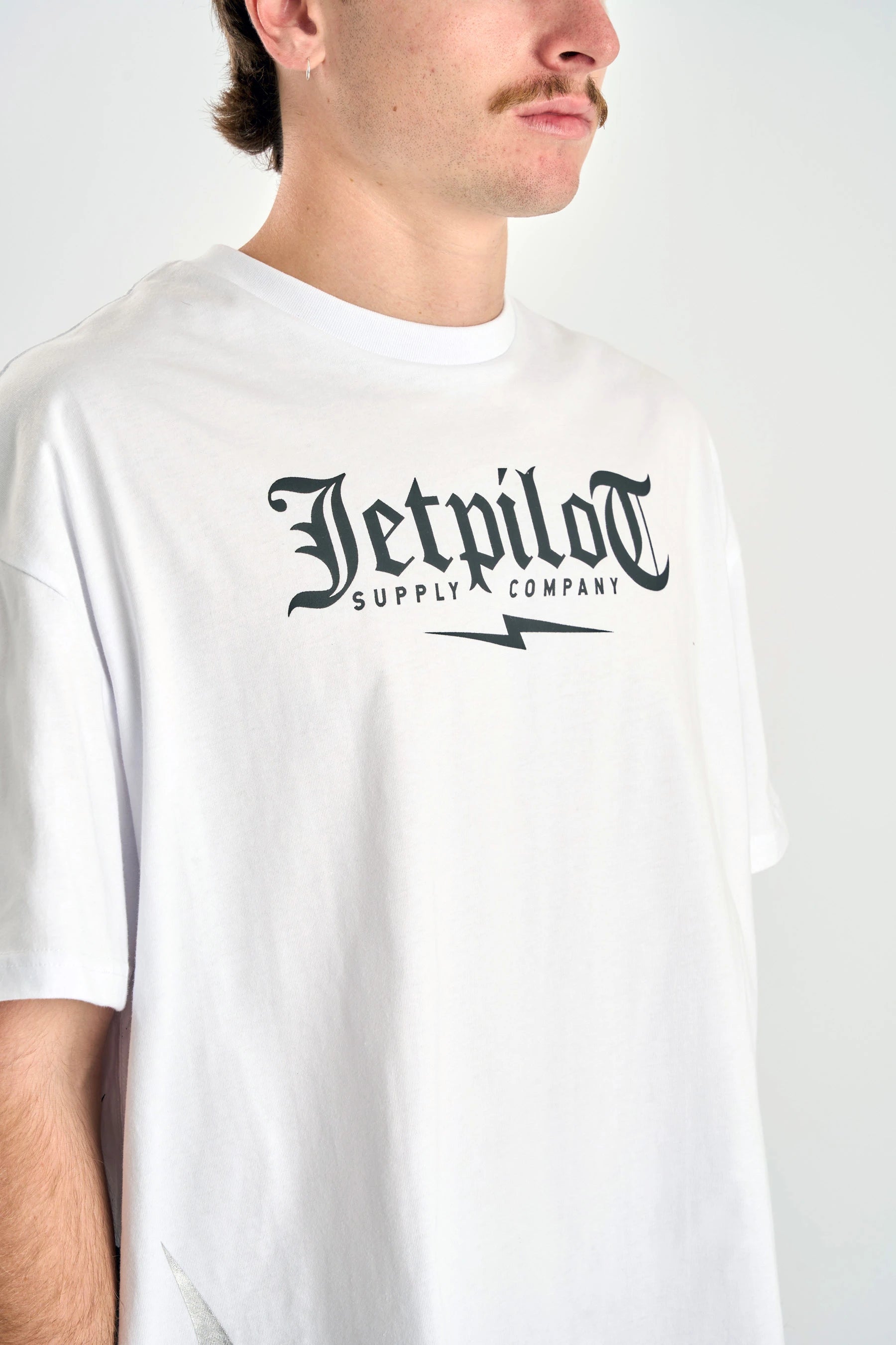 Person wearing a Jetpilot Tribal Heavy Tee - White with 'Jetpilot Supply Company' logo — image 2