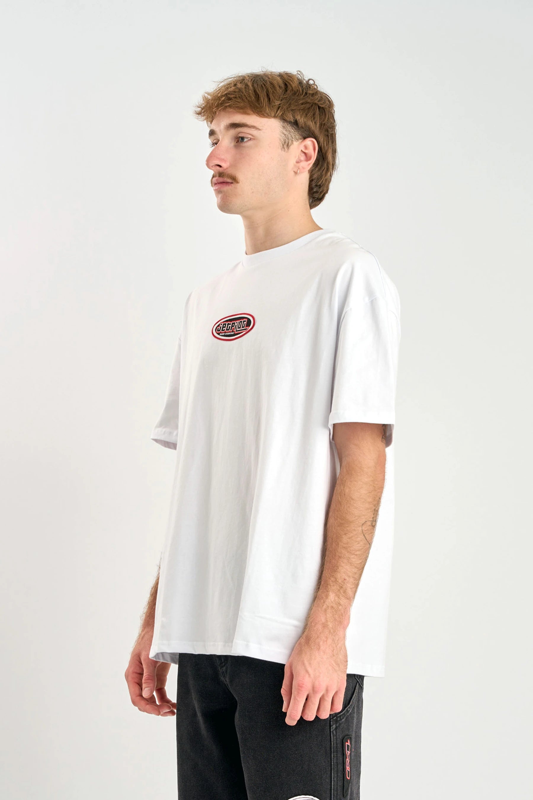 Person wearing a Jetpilot Factory Heavy Tee - White with a red logo on a plain background — image 2