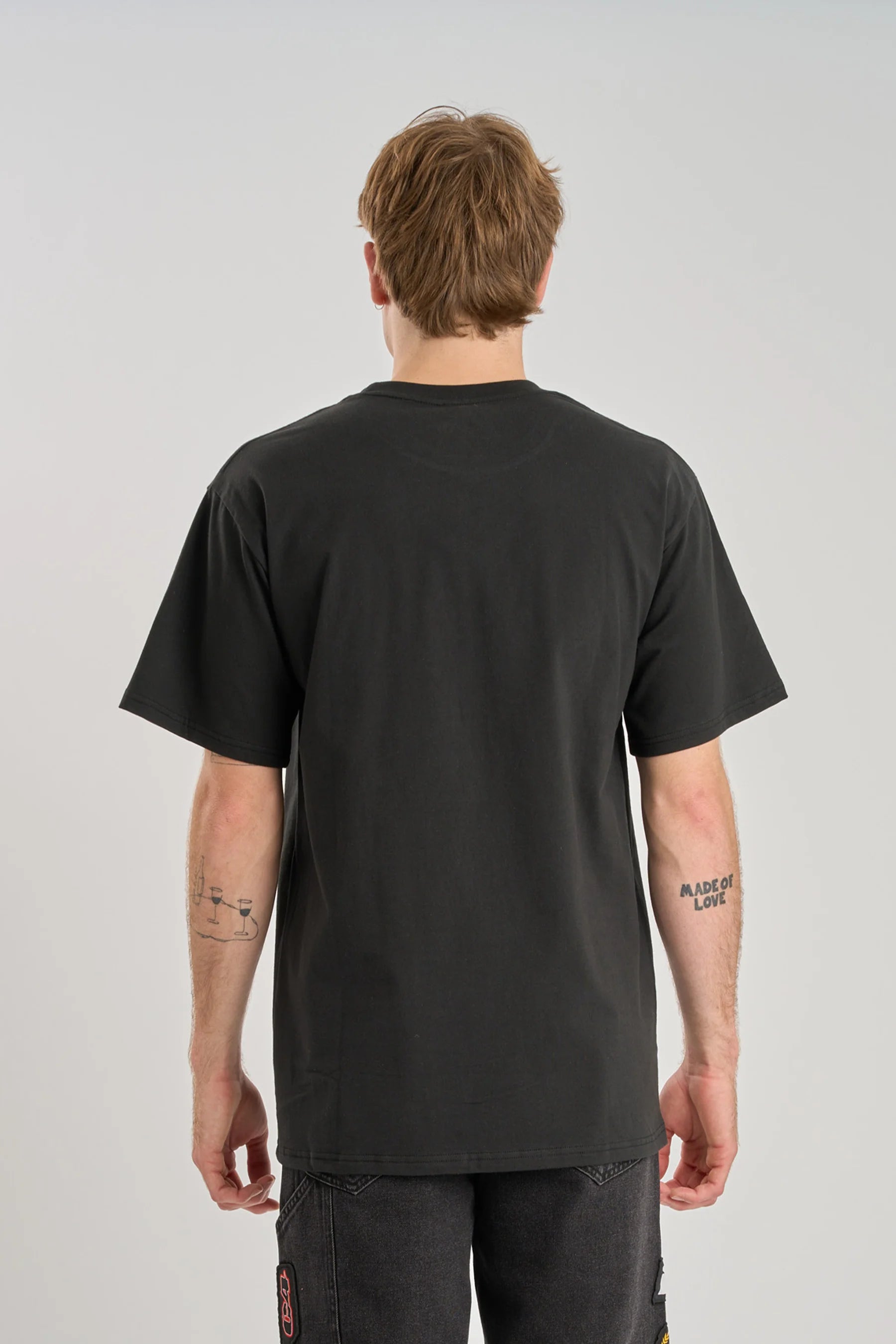 Person wearing a plain black Jetpilot T-Shirt on a plain background