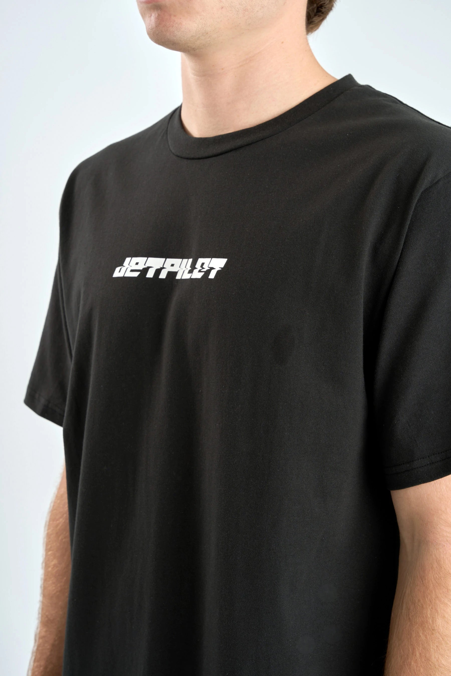 Black t-shirt with white text on a plain background — image 2