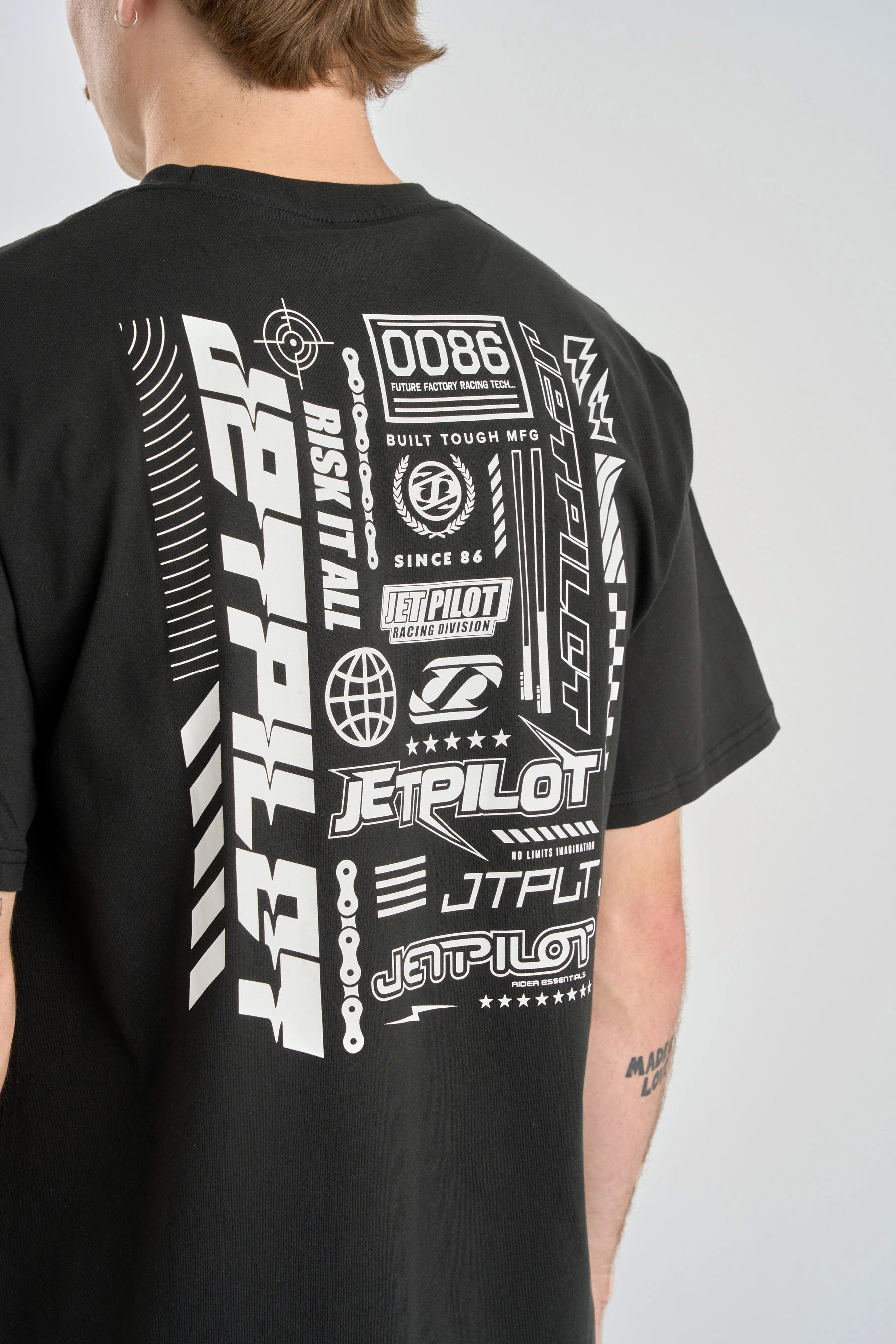 Back of Black t-shirt with white graphics and text on a gray background — image 2