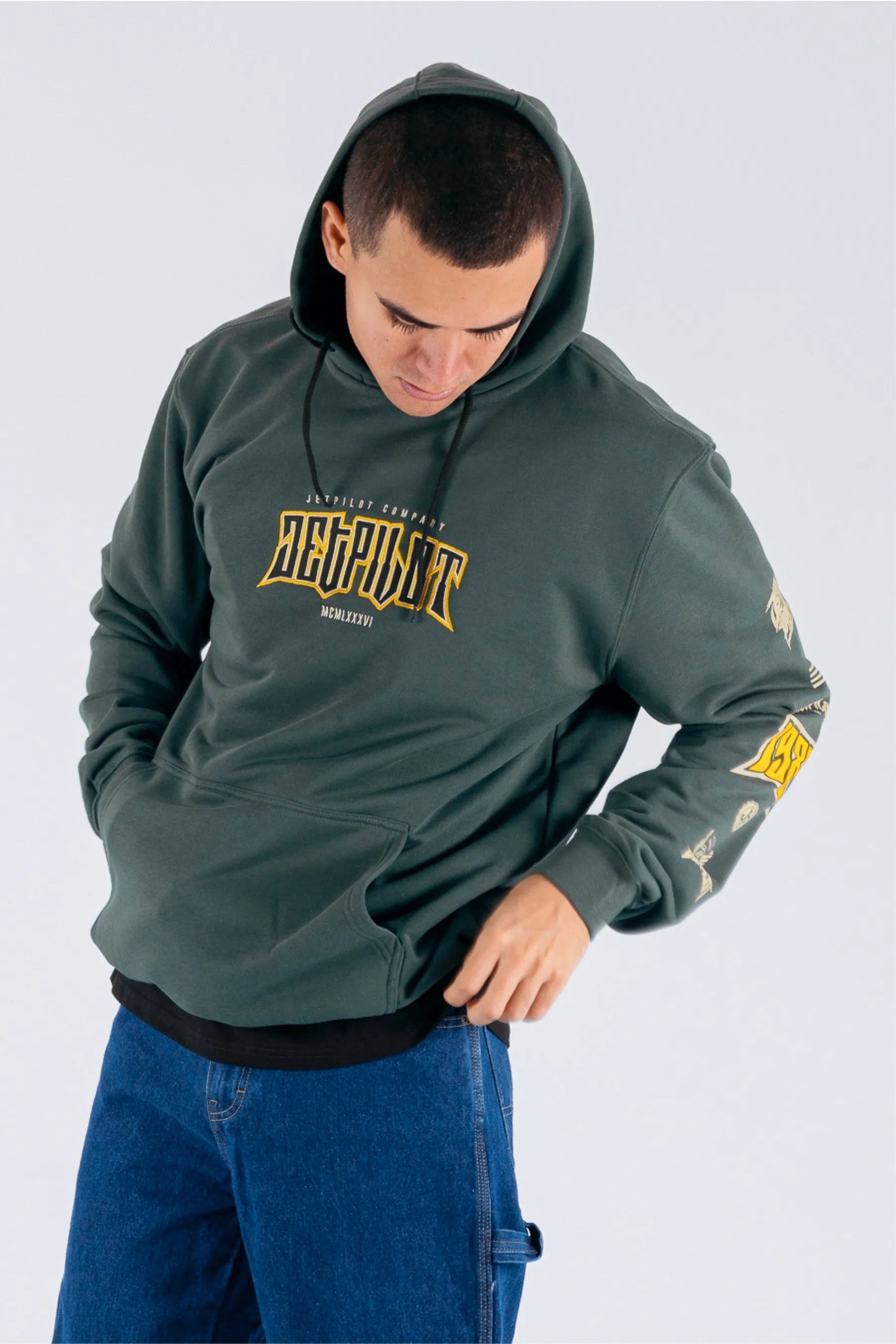 a person wearing an amazon green pullover with a Jetpilot logo — view 5 (3)