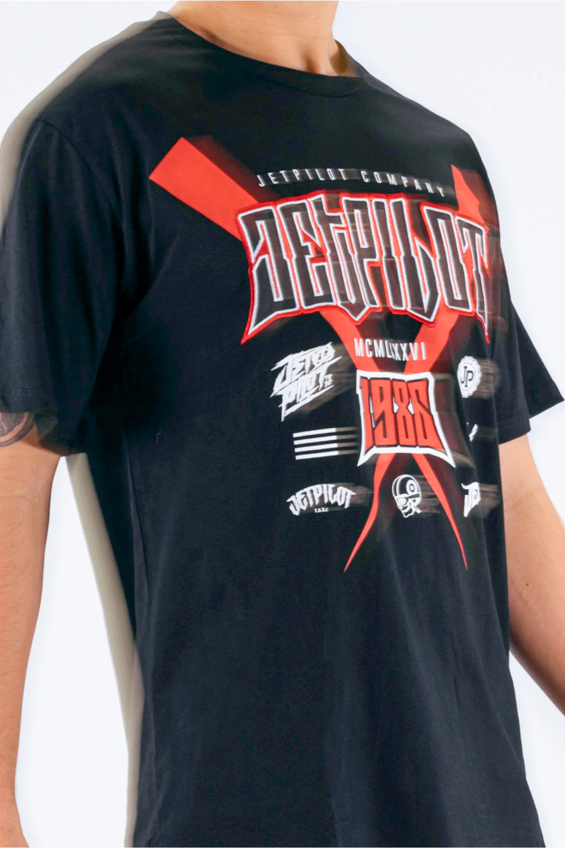 Black t-shirt with red and white graphic design on a person wearing it. — view 5 (3)