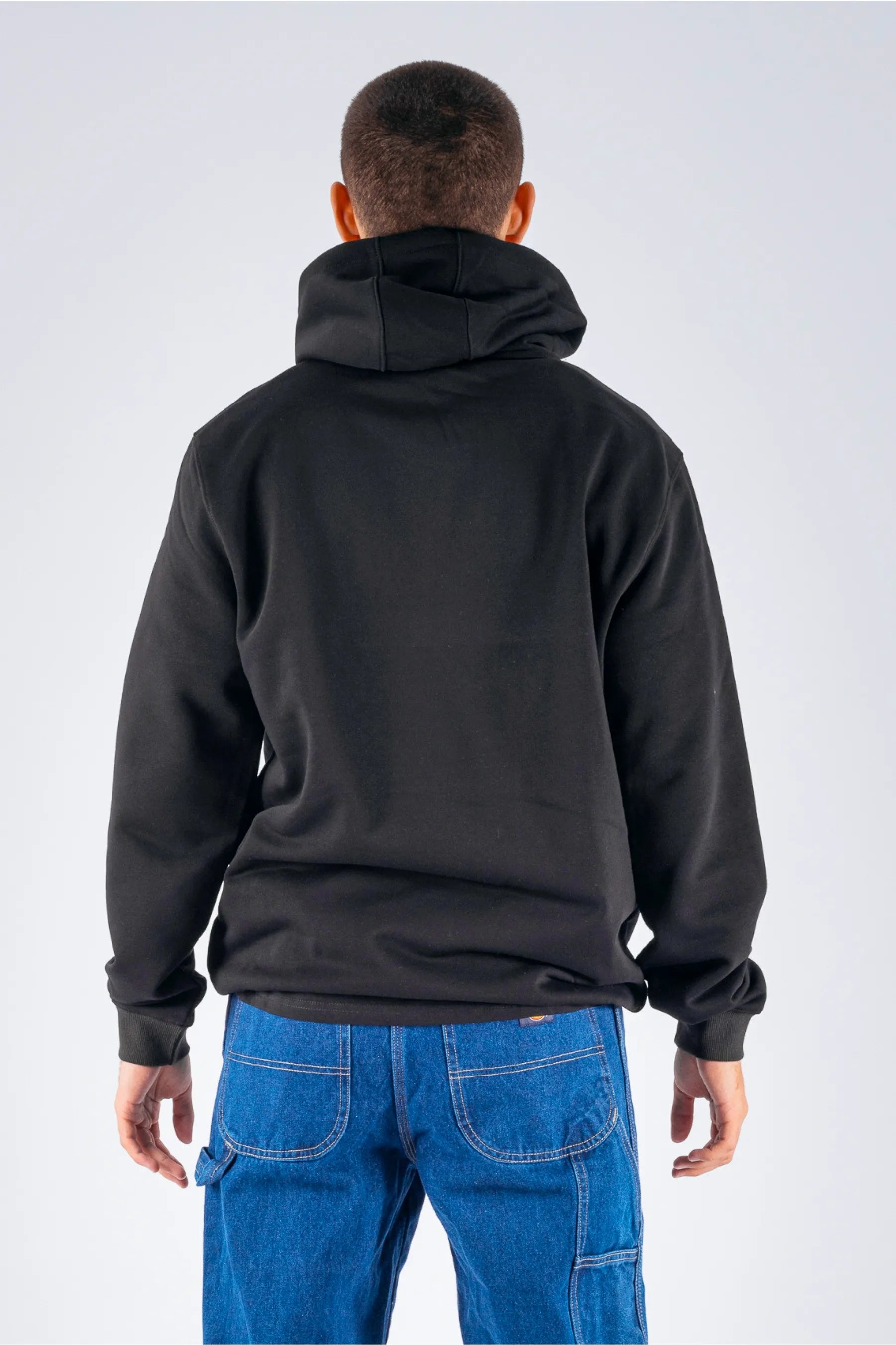 back view of a person wearing a black pullover on a white background — view 2 (3)