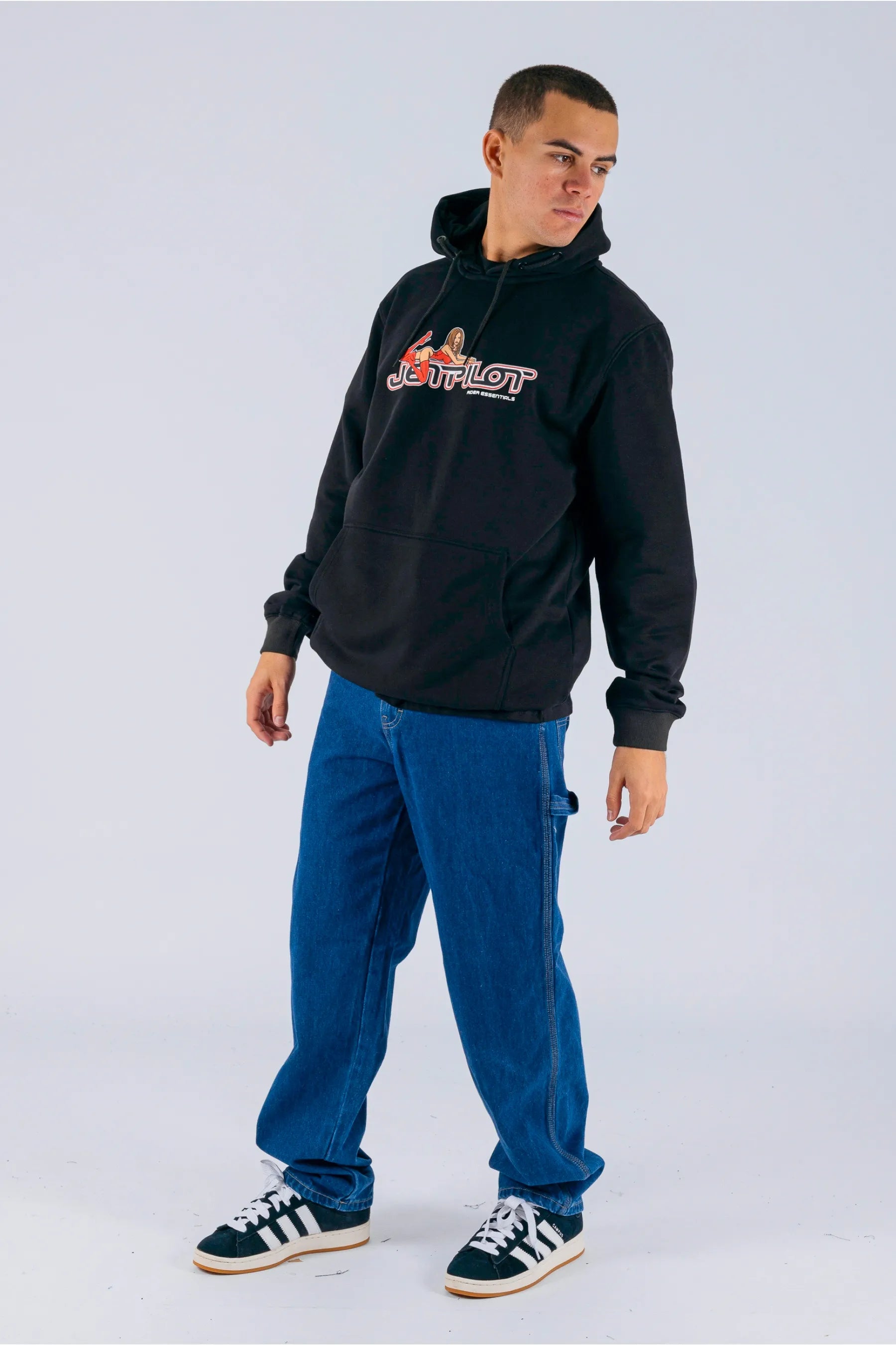 a person wearing a black pullover with a Jetpilot logo, blue shorts and a black/white shoes — view 4 (9)