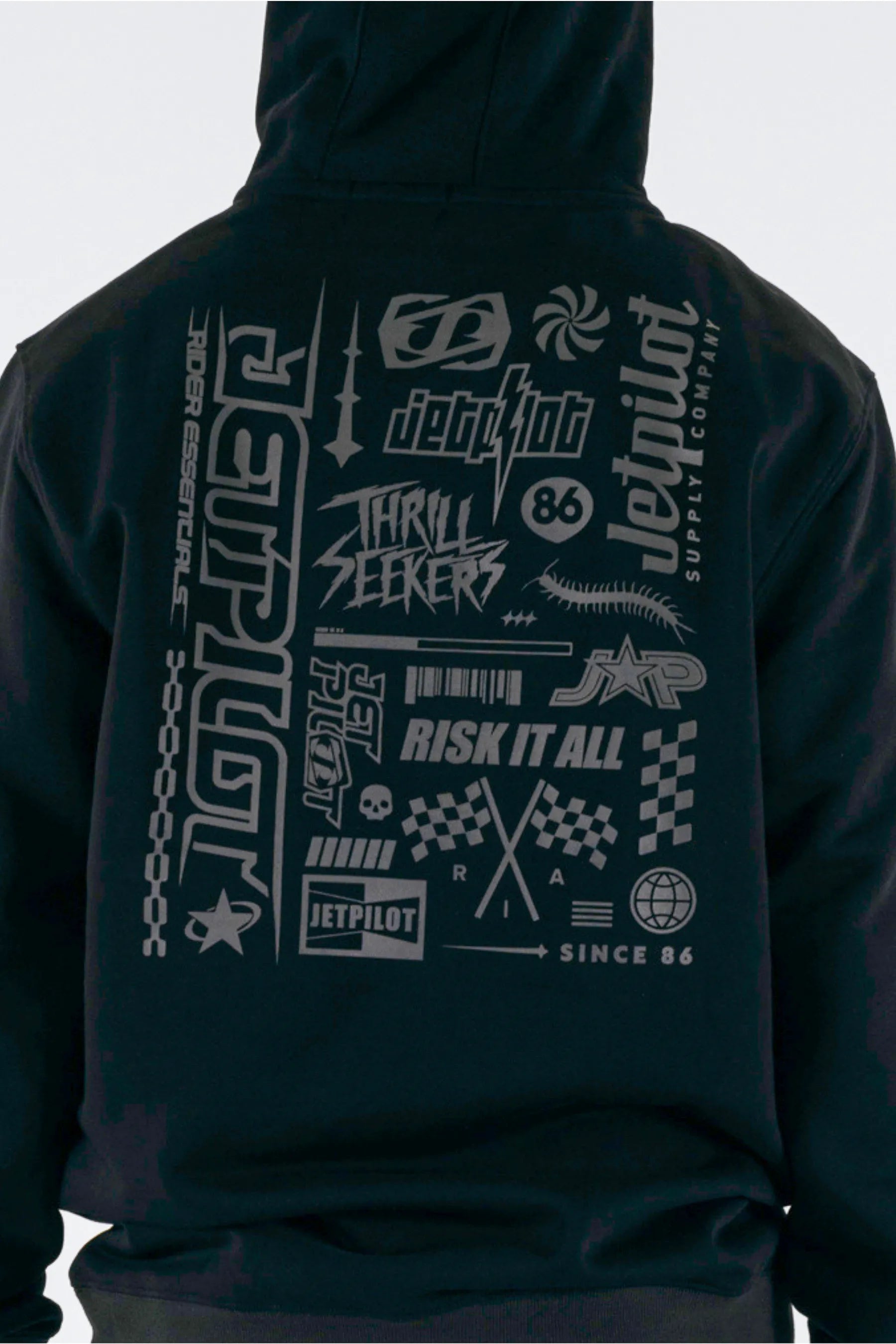 close up of back view of a person wearing a black pullover with a Jetpilot logos on a white background — view 4 (3)