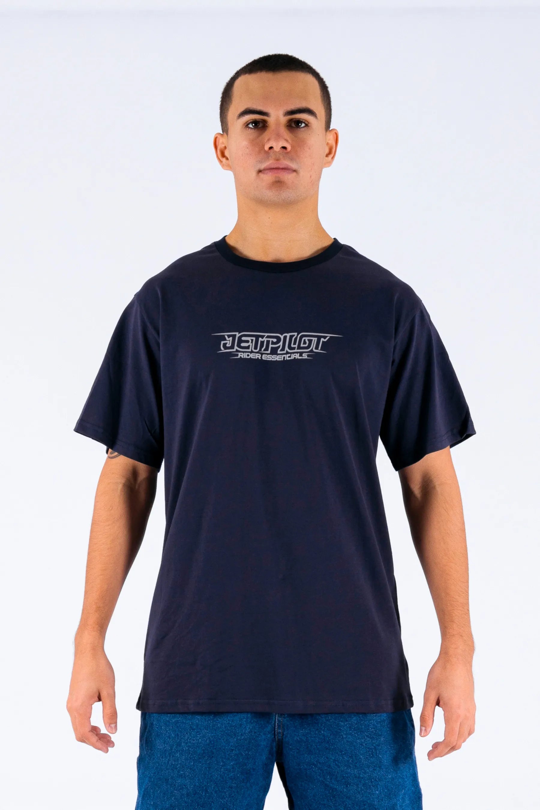 Front view of a person wearing a dark blue tee with a Jetpilot logo on a white background — view 1 (4)