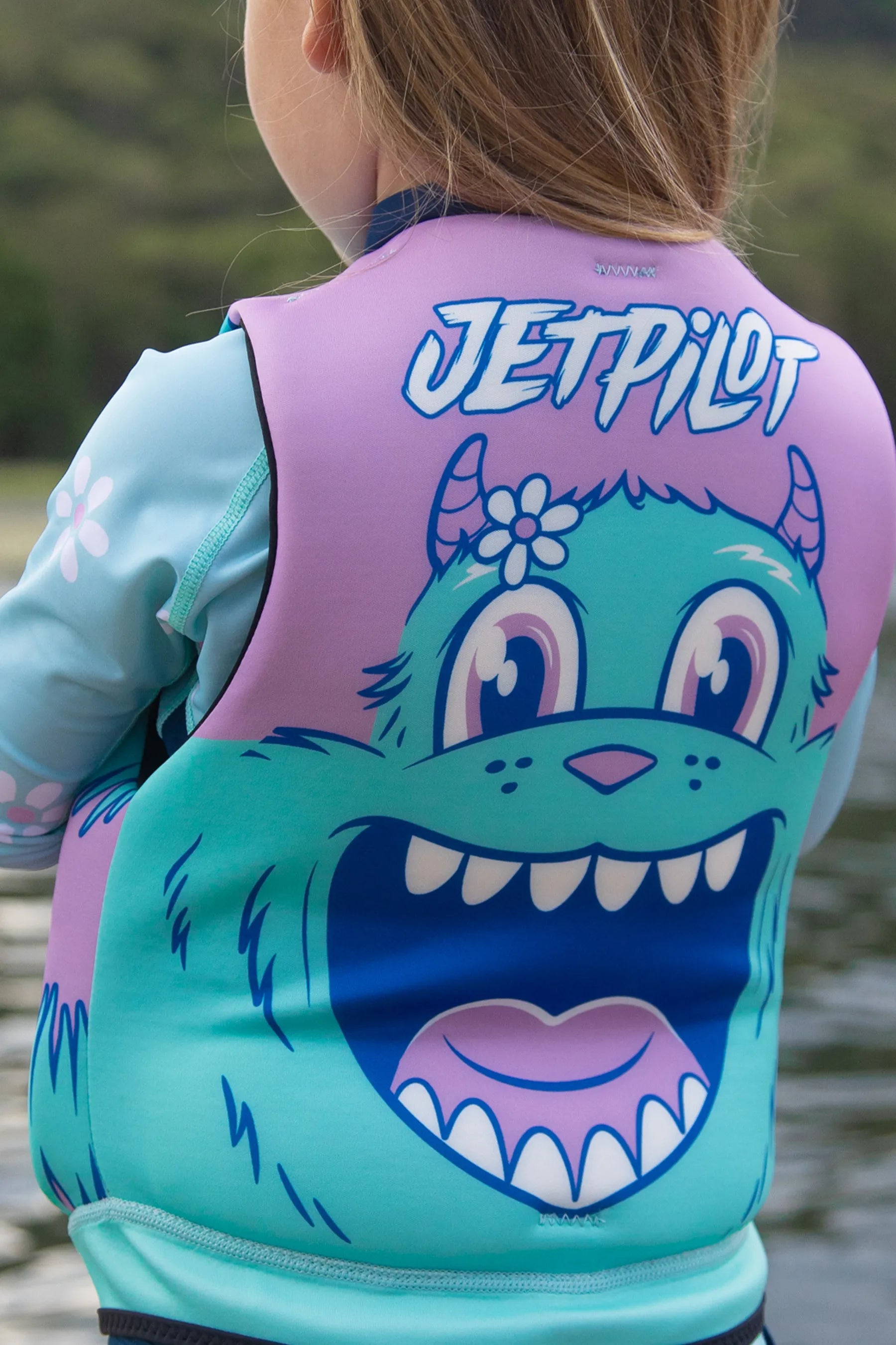 Child wearing a colorful wetsuit with a cartoon character design and 'JetPilot' branding.