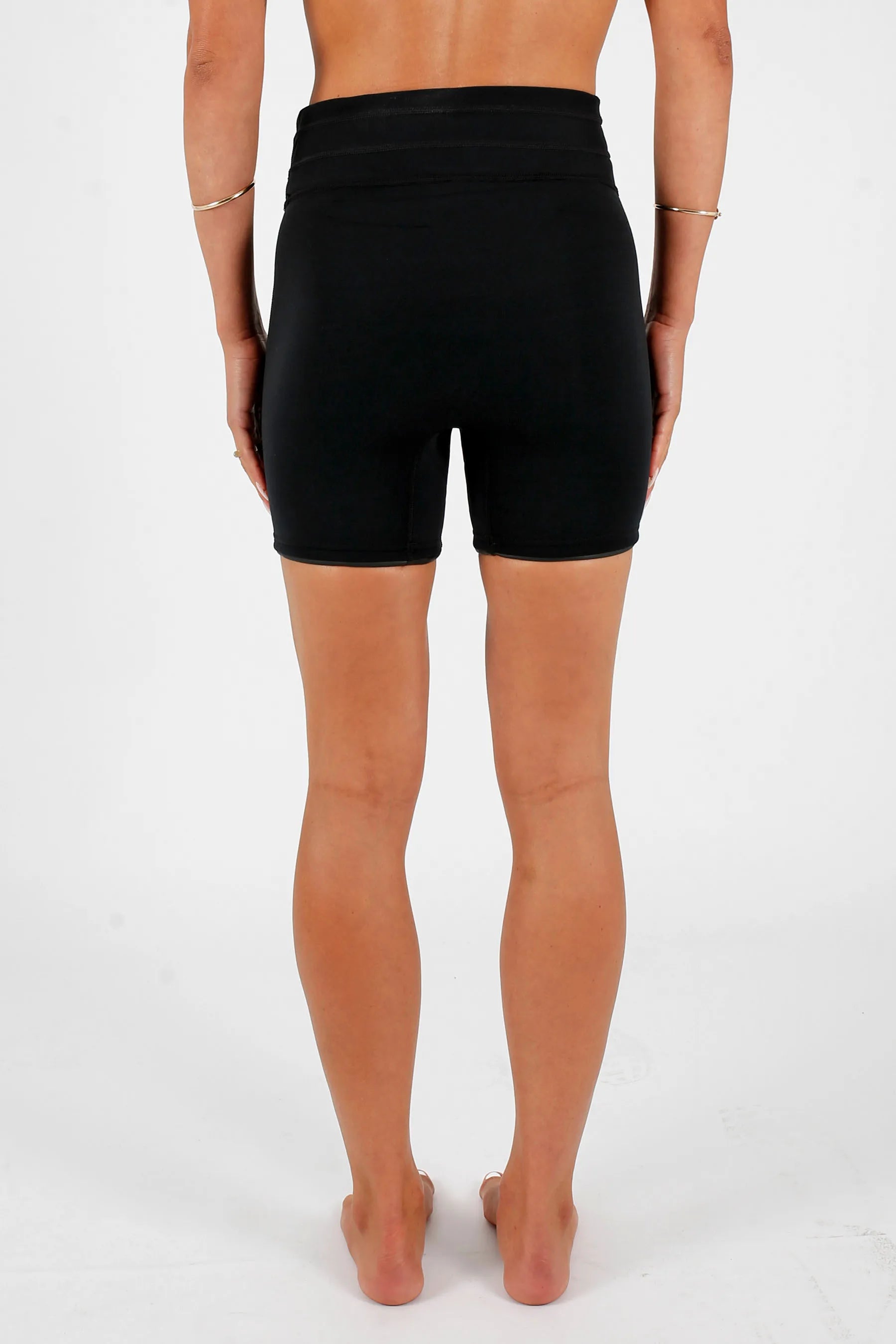 Person wearing Jetpilot Corp 5" High Waisted Neoprene Short - Black on a white background — image 2