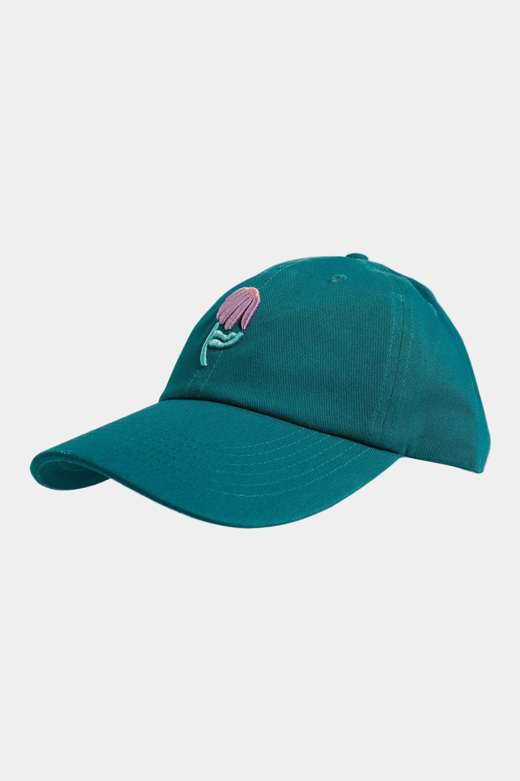 Teal cap with a floral design on a white background