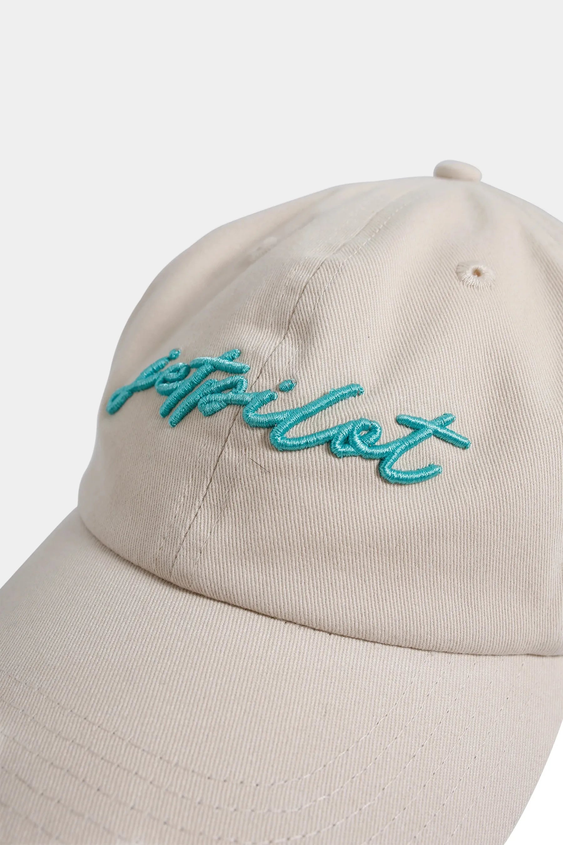 Off-White cap with teal 'Jetpilot' embroidery on a white background