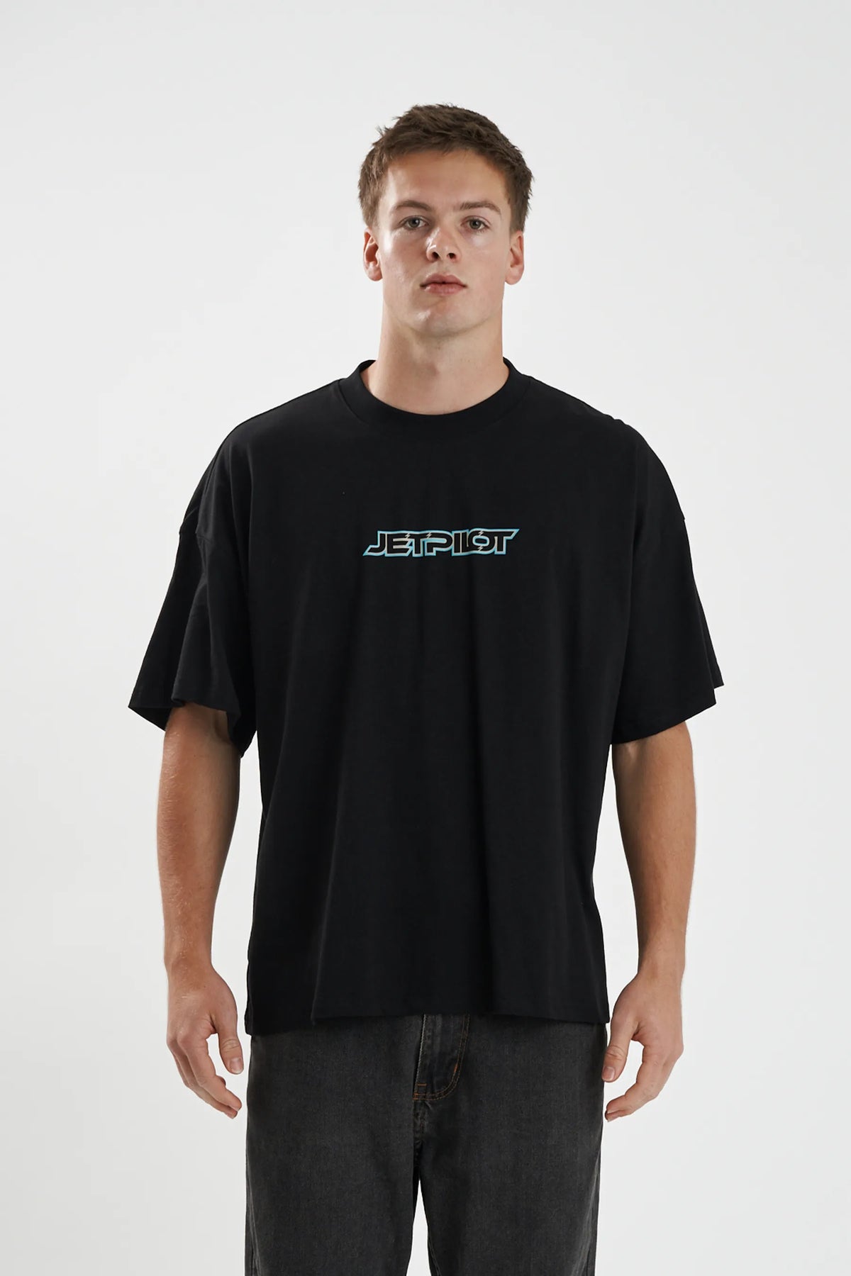 Jetpilot Stocked Up mens oversized graphic tee in Black — front view on a male model