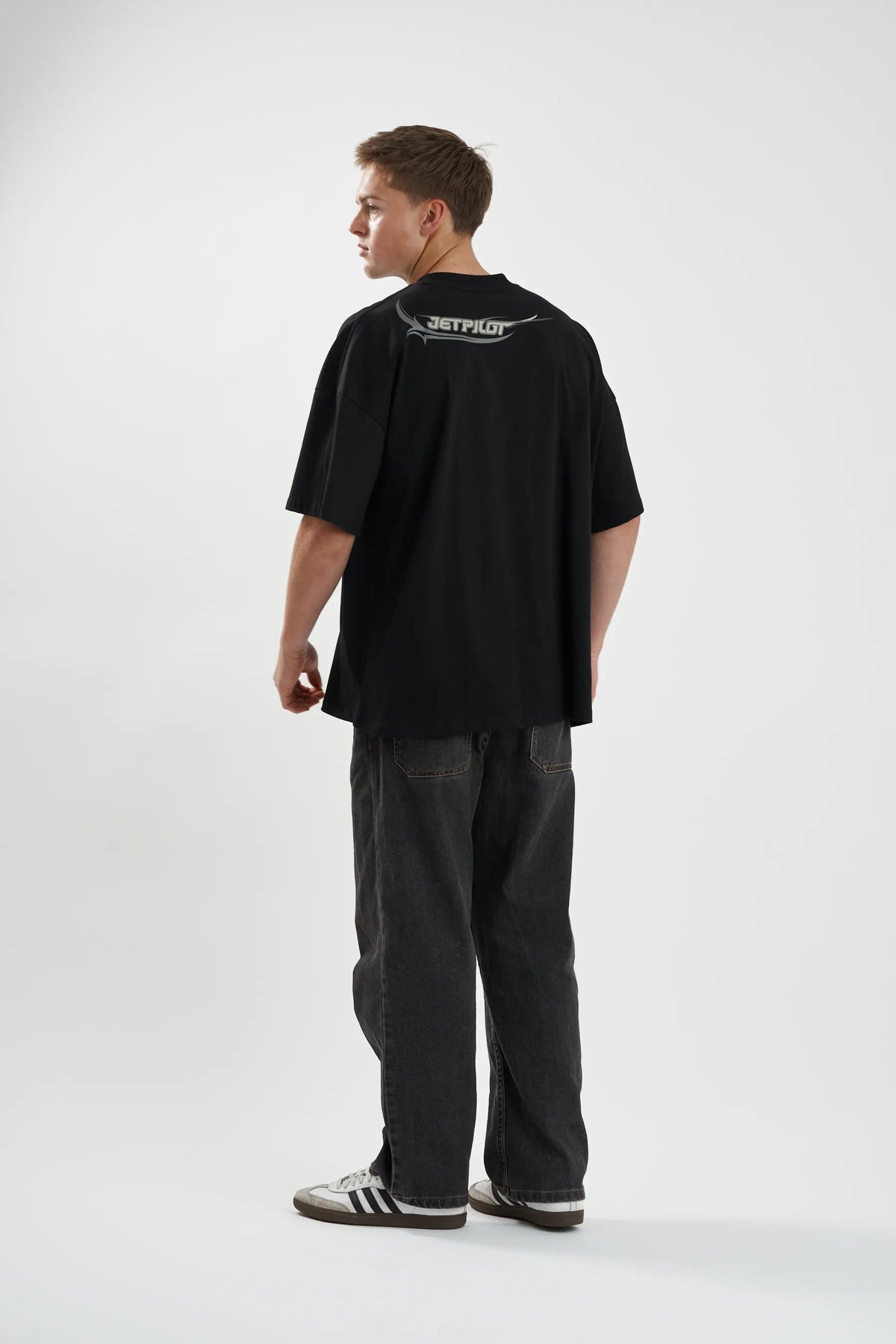 Model looking back over the shoulder in the black Sinister Tee