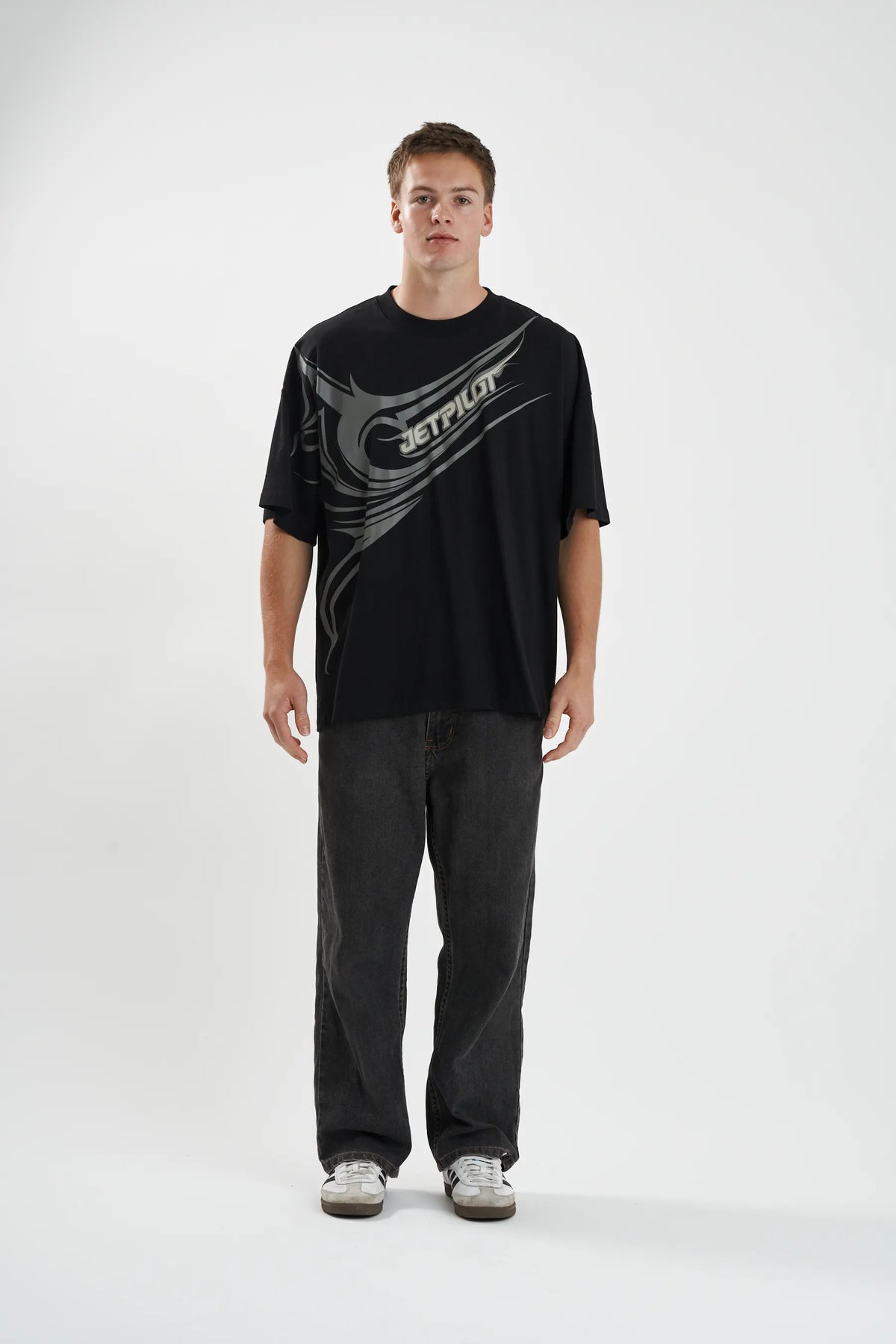 Full-length front view of the black Sinister Tee worn oversized