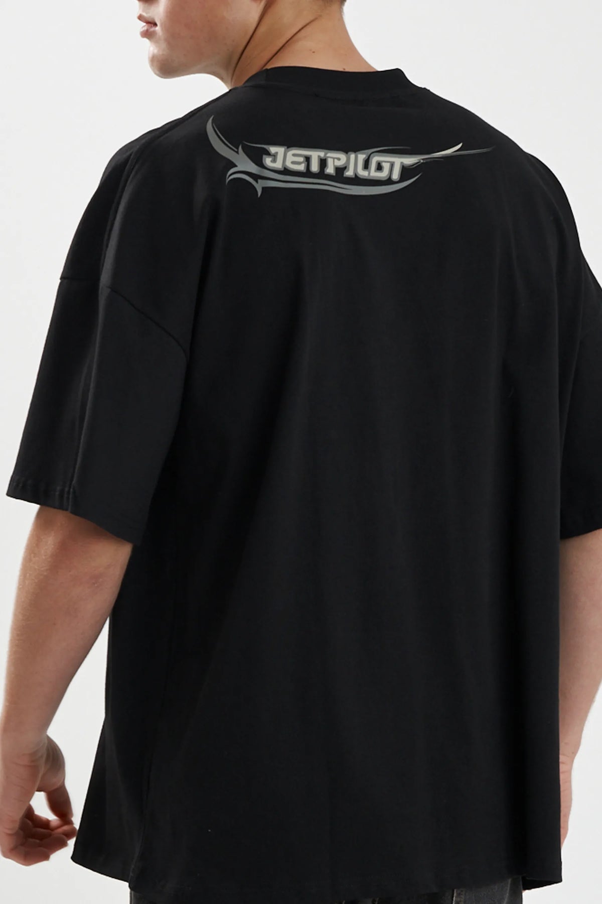 Close-up of the grey back-neck print on the black Sinister Tee