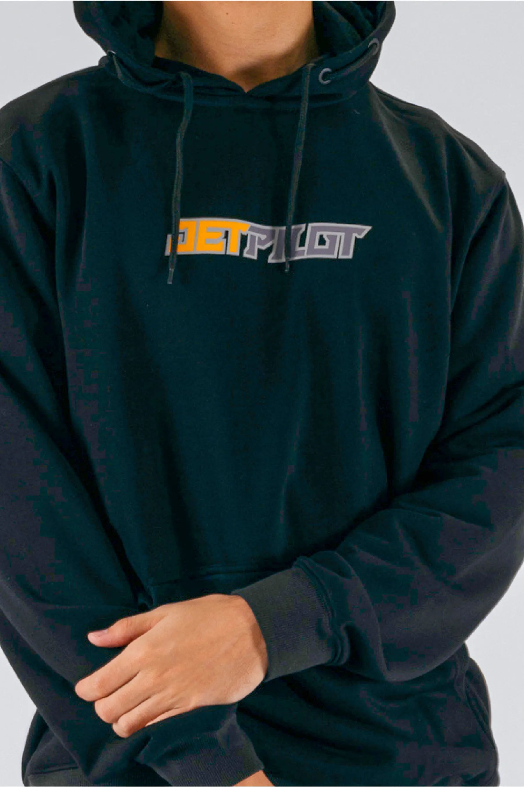 a close up of a person wearing a black pullover with a Jetpilot logo — view 5 (3)