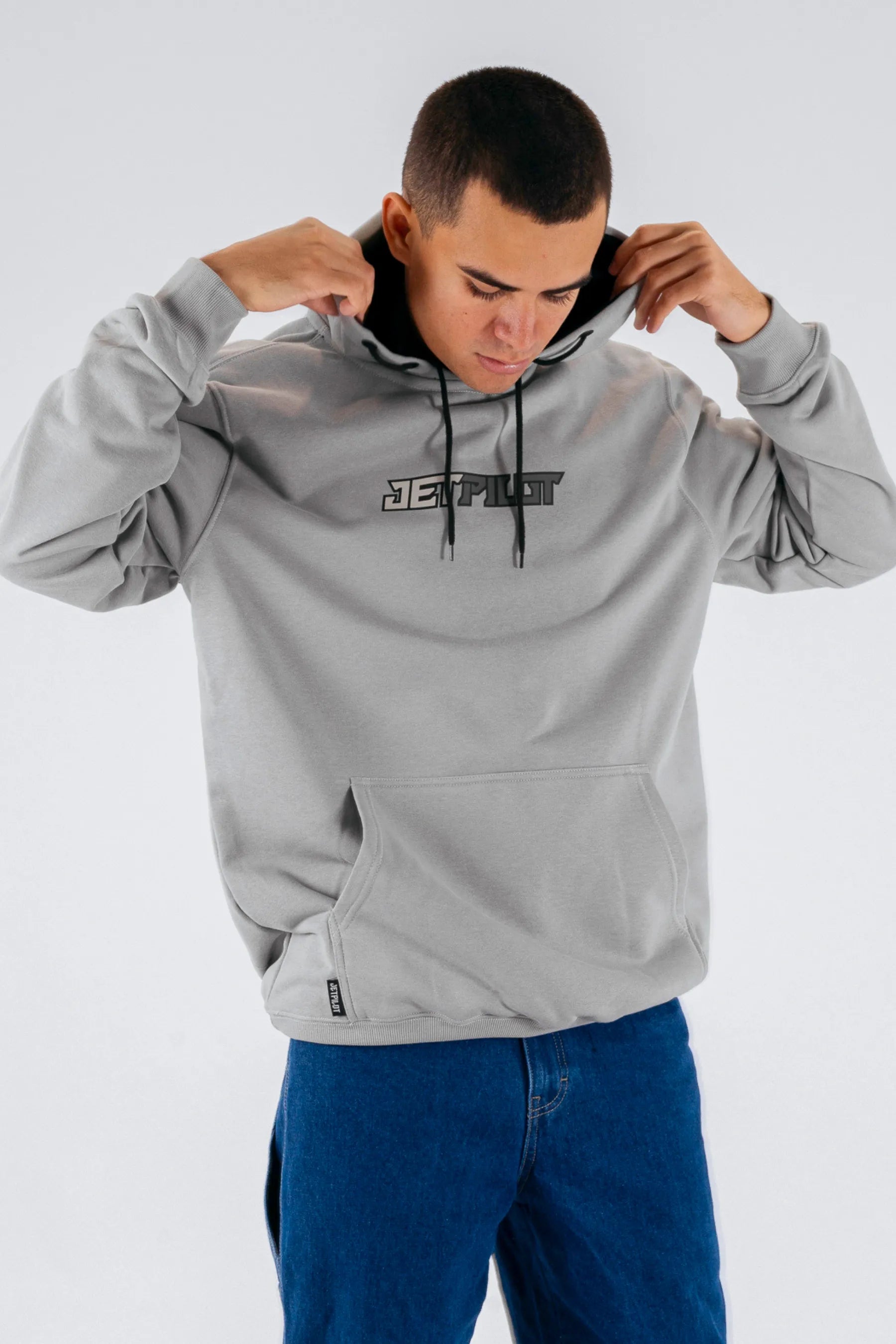 a person wearing a grey pullover with a Jetpilot logo on a white background — view 4 (3)