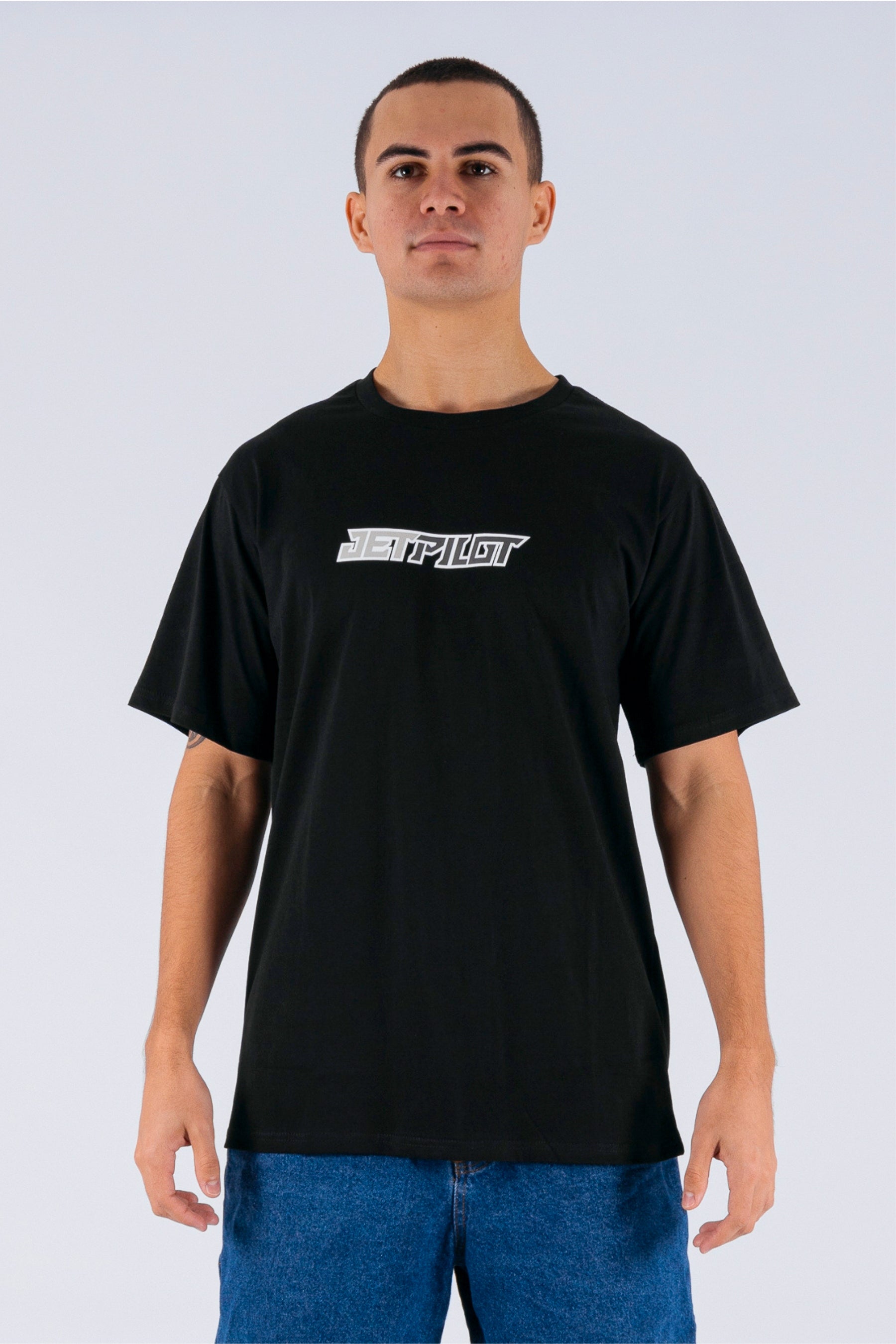 Front view of a person wearing a black tee with a Jetpilot logo on a white background — view 1 (6)