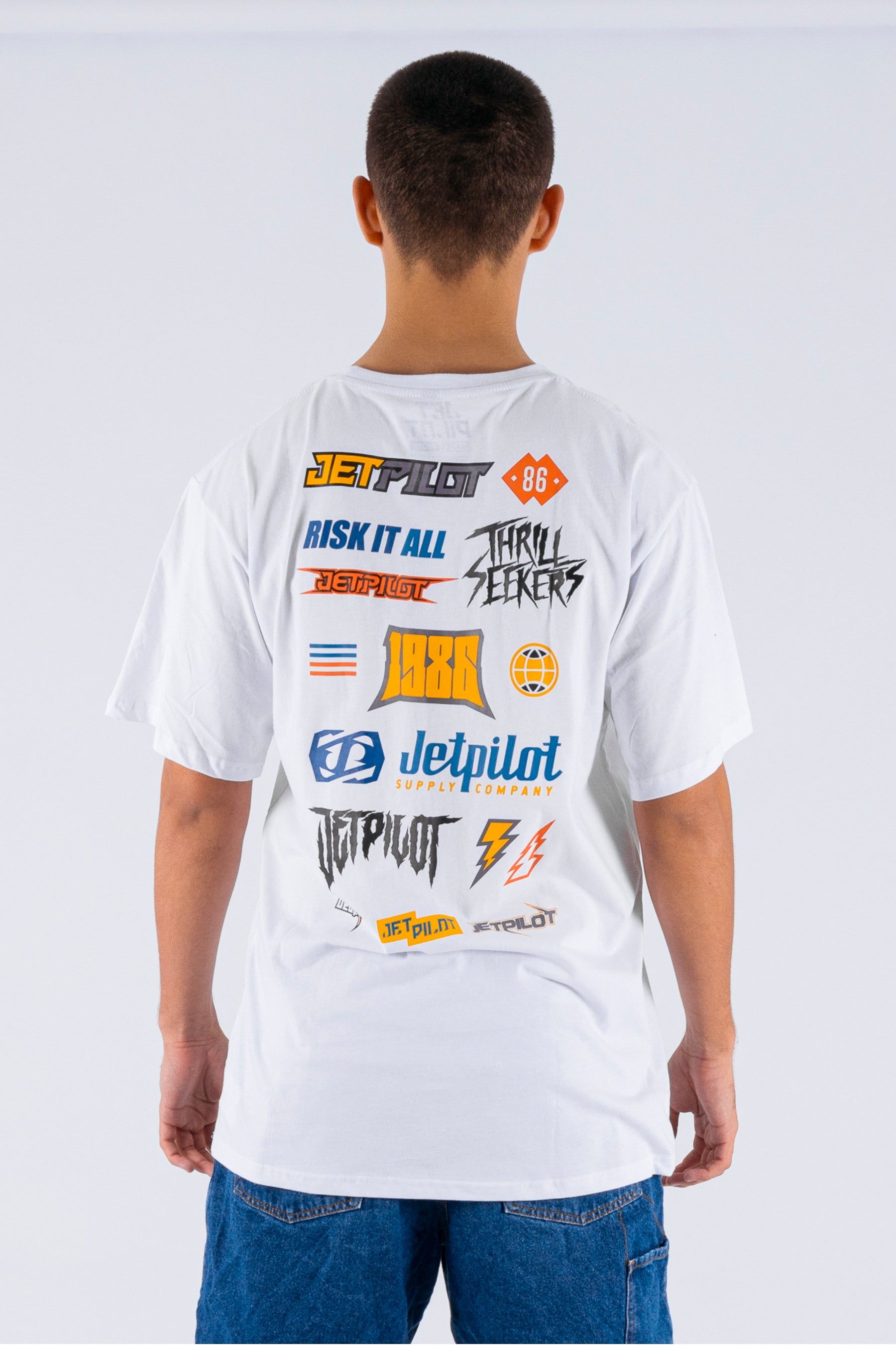 Back view of a person wearing a white tee with a Jetpilot logos on a white background — view 2 (3)
