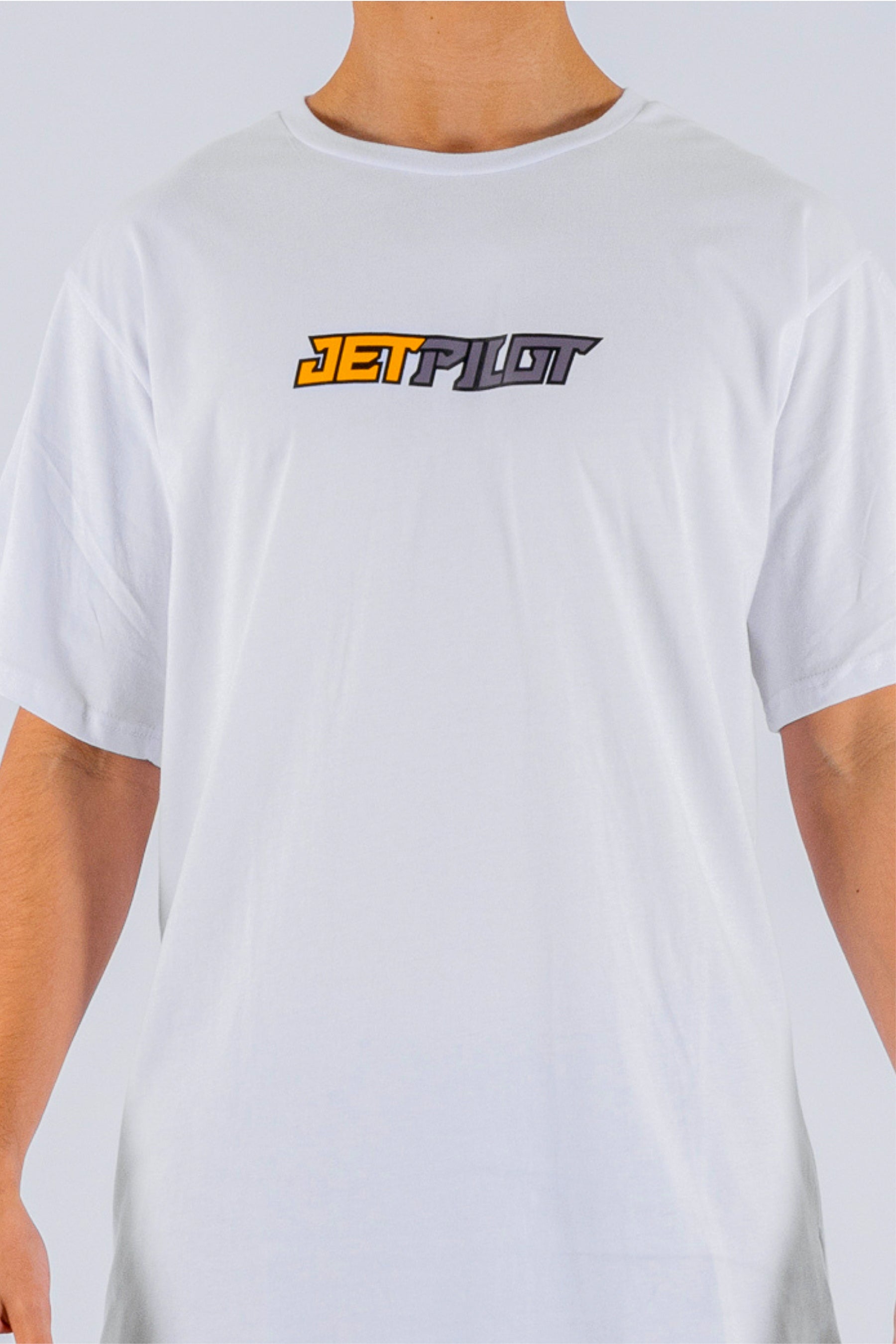 close up of a person wearing a white tee with a Jetpilot logo on a white background — view 5 (5)