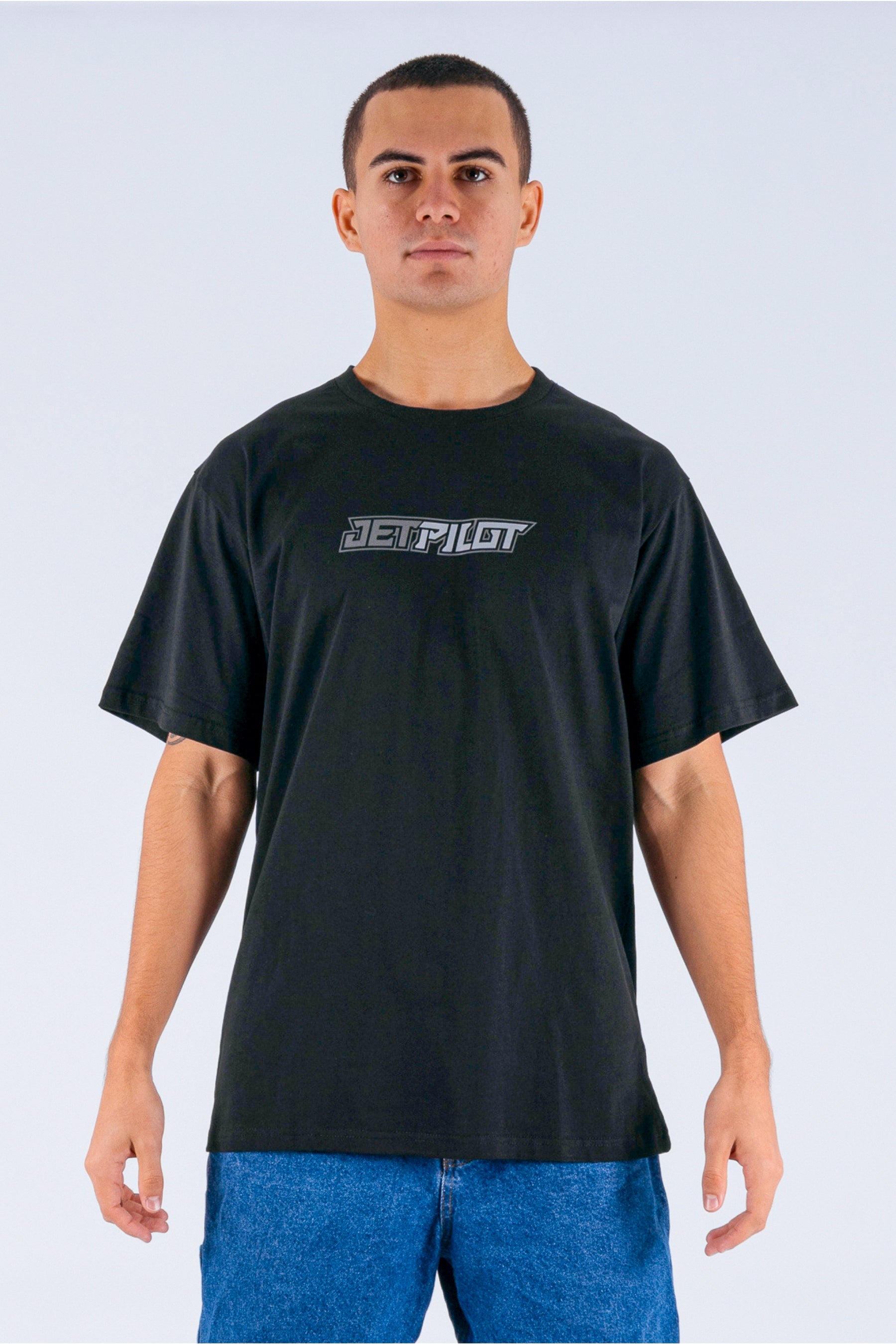 Front view of a person wearing a black tee with a Jetpilot logo on a white background — view 1 (7)