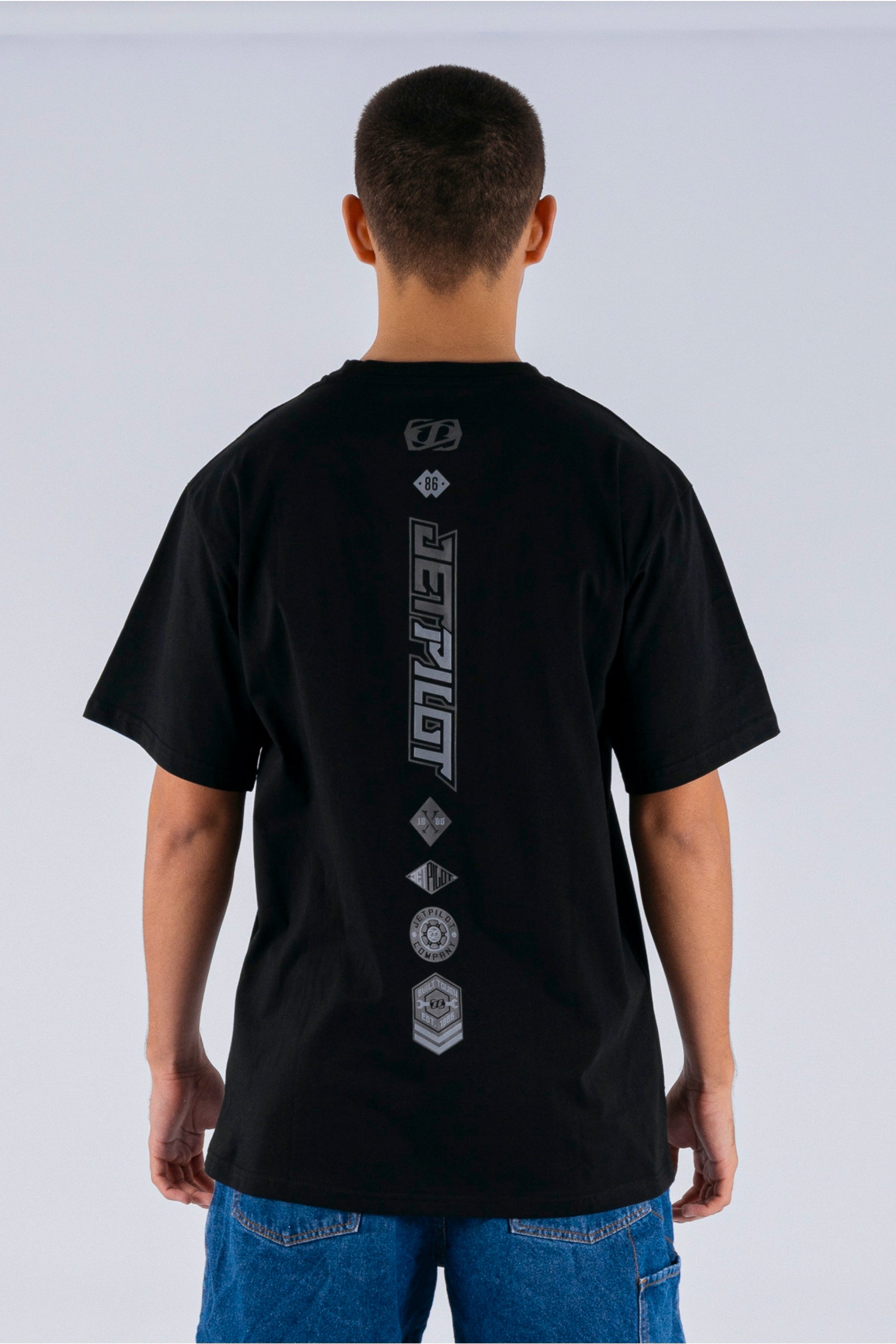 back view of a person wearing a black tee with Jetpilot logos on a white background — view 2 (5)