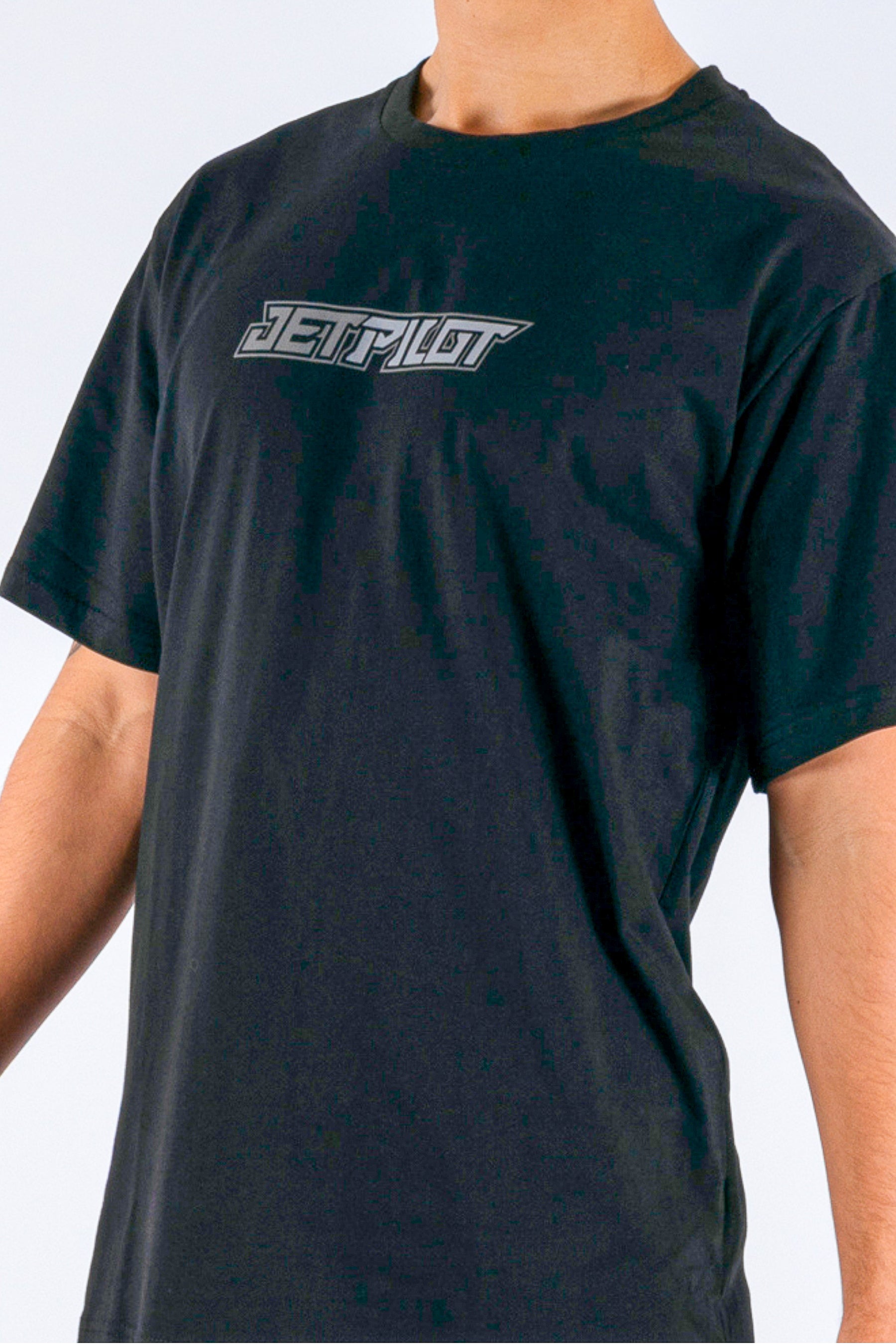 close up of a person wearing a black tee with a Jetpilot logo on a white background — view 4 (7)