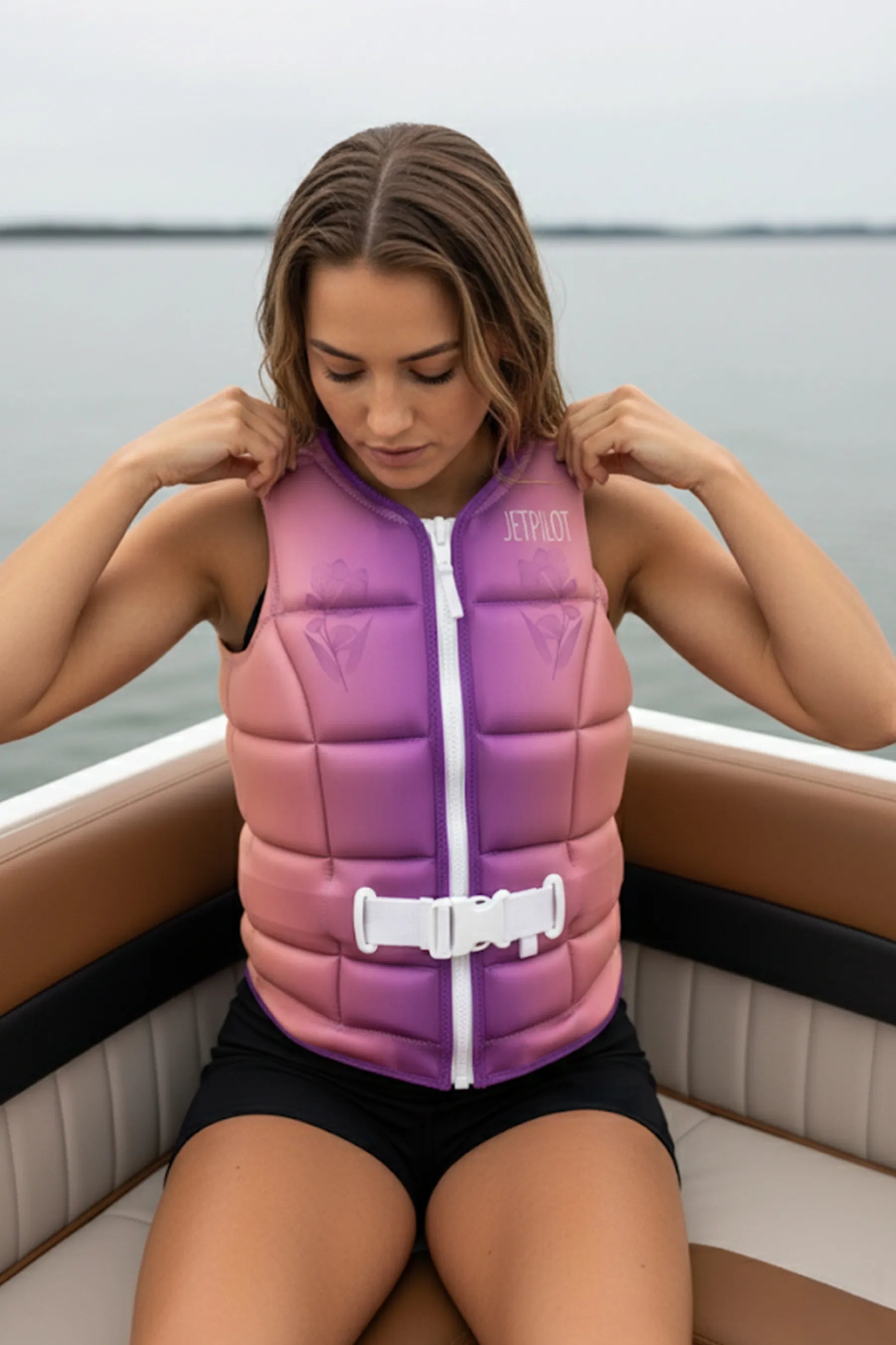 Woman wearing a Jetpilot Aurora Ladies Life Jacket - Purple on a boat