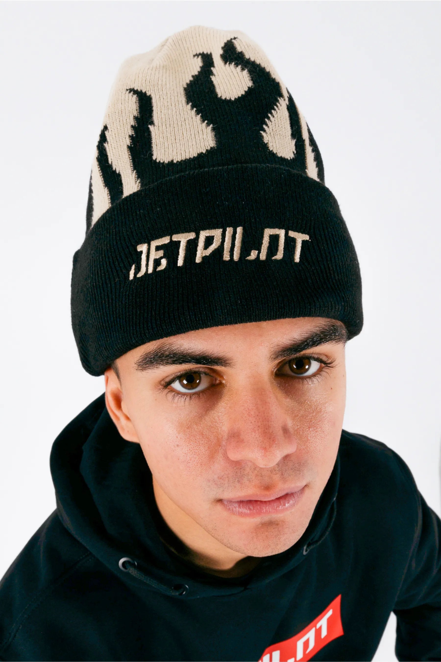 Close up of a person wearing a cement beanie with Jetpilot logo on a white background — view 2 (3)