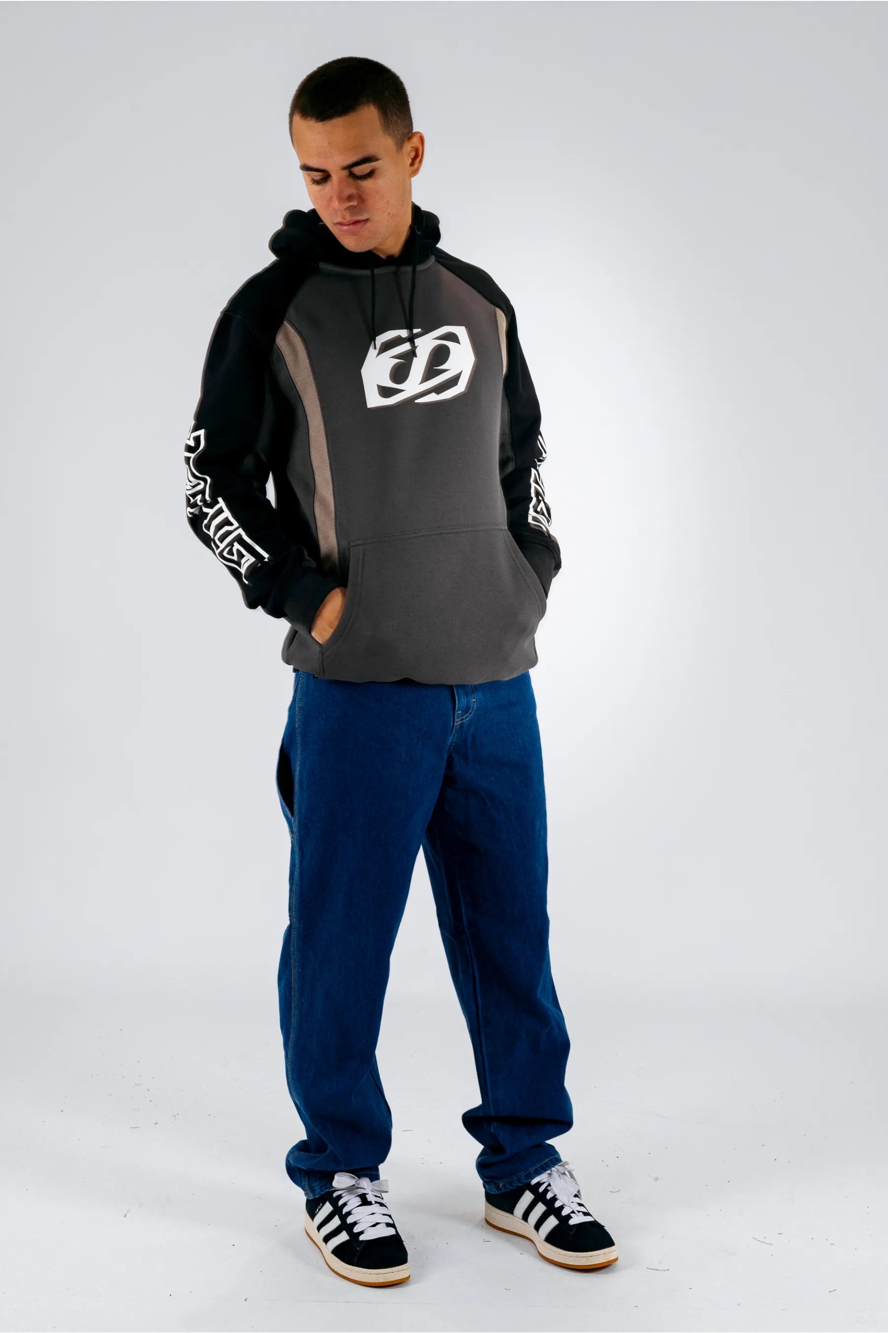 a person wearing a black pullover with a Jetpilot logo, blue shorts and a black/white shoes — view 3 (7)